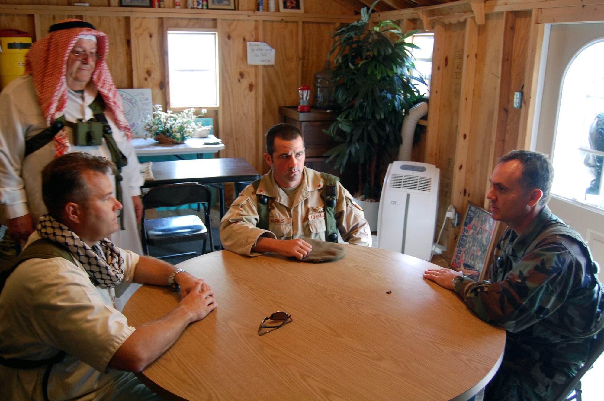 Col. Darrell Riggs (right), commander of the 95th Mission Support Group, Edwards Air Force Base, Calif., talks with "local villagers" in the fictional village of Citheron during a scenario for Air Force Exercise Eagle Flag 08-6 Sept. 19, 2008, at Naval Air Engineering Station Lakehurst, N.J.  The exercise, managed by the U.S. Air Force Expeditionary Center's 421st Combat Training Squadron from Fort Dix, N.J., tests and trains more than 400 Airmen in expeditionary combat support skills.  (U.S. Air Force Photo/Tech. Sgt. Scott T. Sturkol)