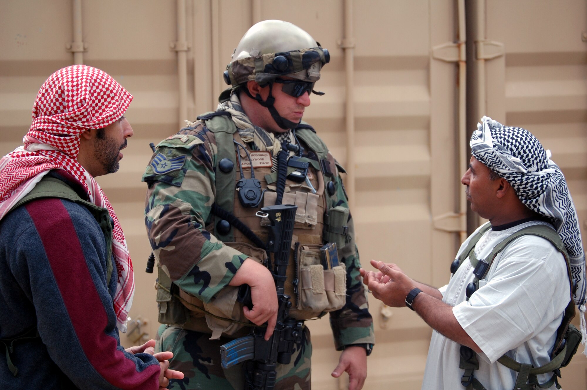 Staff Sgt. Bryan MacDonald, from the 816th Contingency Response Group, McGuire Air Force Base, N.J., talks with "local villagers" in the fictional village of Citheron during a scenario for Air Force Exercise Eagle Flag 08-6 Sept. 19, 2008, at Naval Air Engineering Station Lakehurst, N.J.  The exercise, managed by the U.S. Air Force Expeditionary Center's 421st Combat Training Squadron from Fort Dix, N.J., tests and trains more than 400 Airmen in expeditionary combat support skills.  (U.S. Air Force Photo/Tech. Sgt. Scott T. Sturkol)
