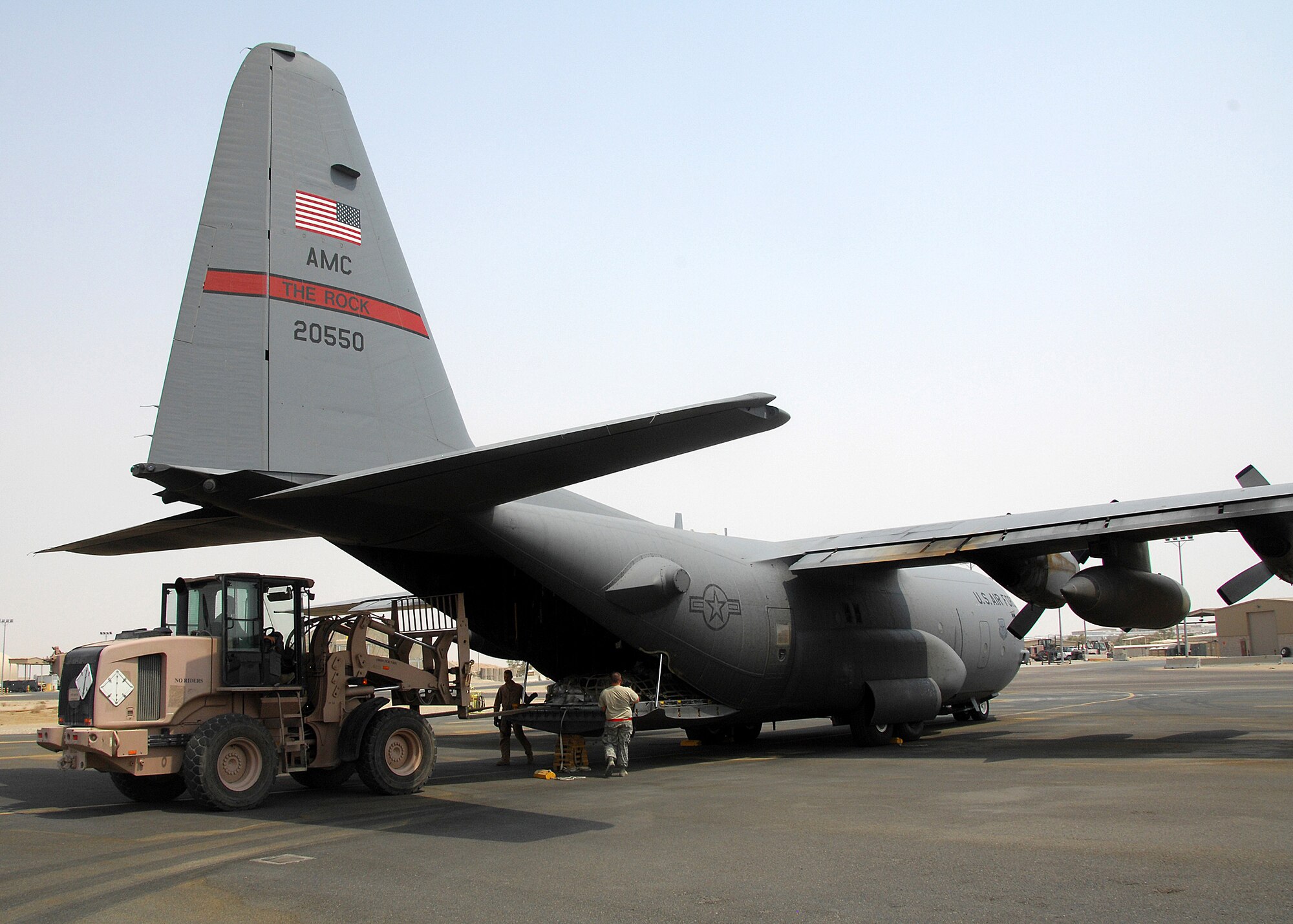 SOUTHWEST ASIA -- Members of the 386th Expeditionary Logistics Readiness Squadron Aerial Port section load equipment pallets on a C-130 Hercules bound for Iraq on Sept. 9 at an air base in Southwest Asia. Aerial port Airmen recently completed a "back to the basics" course focusing on safety and key aspects of their workcenter duties and responsibilities. The section is responsible for passenger and cargo movement of aircraft operating throughout the U.S. Central Command area of responsibility. The section has moved more than 400,000 passengers and 63,000 pounds of cargo to date. (U.S. Air Force photo/Tech. Sgt. Raheem Moore)
