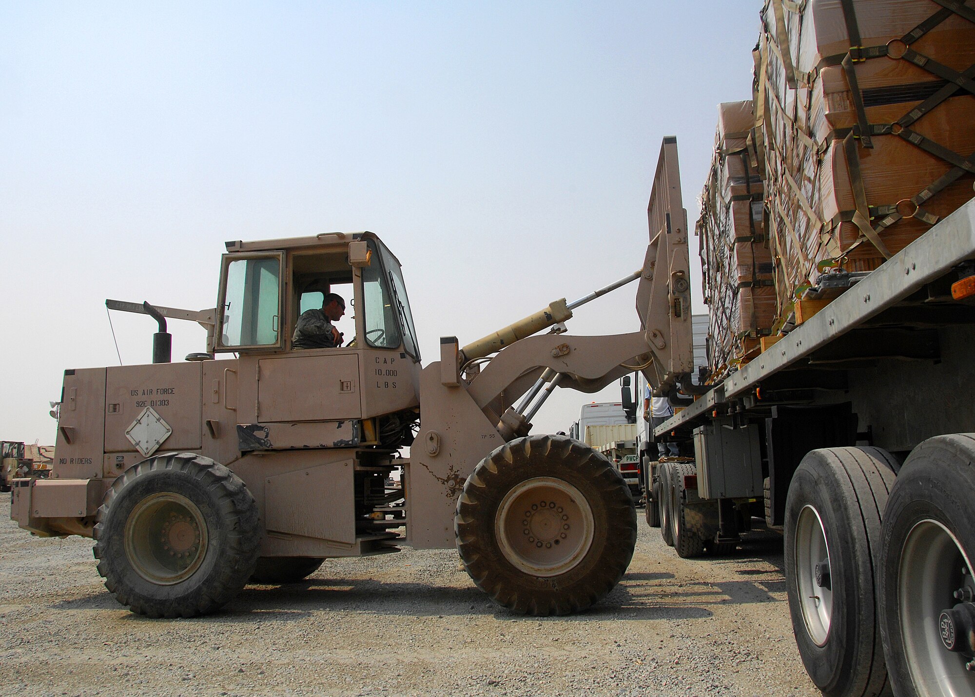 SOUTHWEST ASIA -- Members of the 386th Expeditionary Logistics Readiness Squadron Aerial Port section remove equipment pallets off a flatbed truck on Sept. 9 at an air base in Southwest Asia. Aerial port Airmen recently completed a "back to the basics" course focusing on safety and key aspects of their workcenter duties and responsibilities. The section is responsible for passenger and cargo movement of aircraft operating throughout the U.S. Central Command area of responsibility. The section has moved more than 400,000 passengers and 63,000 pounds of cargo to date. (U.S. Air Force photo/Tech. Sgt. Raheem Moore)
