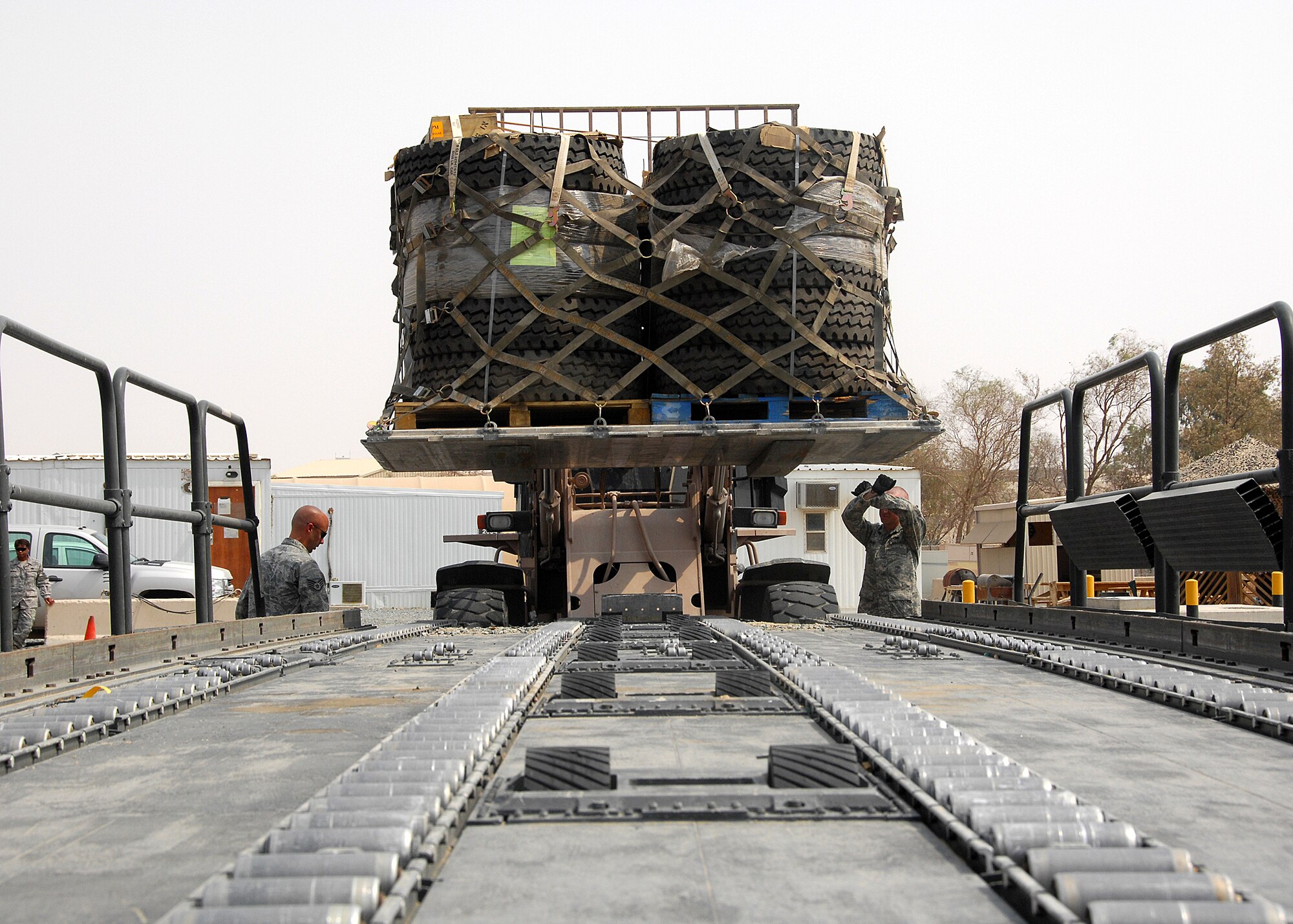 SOUTHWEST ASIA -- Members of the 386th Expeditionary Logistics Readiness Squadron Aerial Port section load a pallet of tires onto a K-Loader on Sept. 9 at an air base in Southwest Asia. Aerial port Airmen recently completed a "back to the basics" course focusing on safety and key aspects of their workcenter duties and responsibilities. The section is responsible for passenger and cargo movement of aircraft operating throughout the U.S. Central Command area of responsibility. The section has moved more than 400,000 passengers and 63,000 pounds of cargo to date. (U.S. Air Force photo/Tech. Sgt. Raheem Moore)