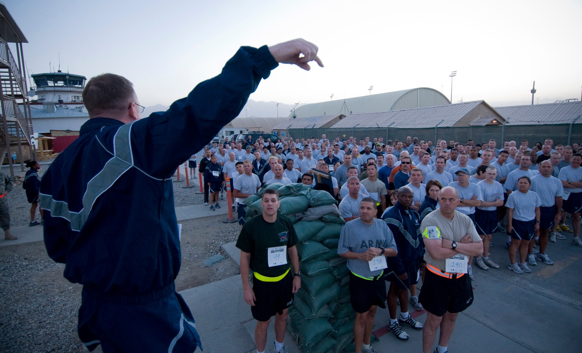 BAGRAM AIR FIELD, Afghanistan -- Chief Master Sgt. David Fanning, 455th Expeditionary Maintenance Group first sergeant, explains the 5-kilometer run course here September 20, 2008. Airmen, soldiers, marines, sailors, and other coalition forces lined up side-by-side for this special event.  (U.S. Air Force photo by Staff Sgt. Samuel Morse/Released)