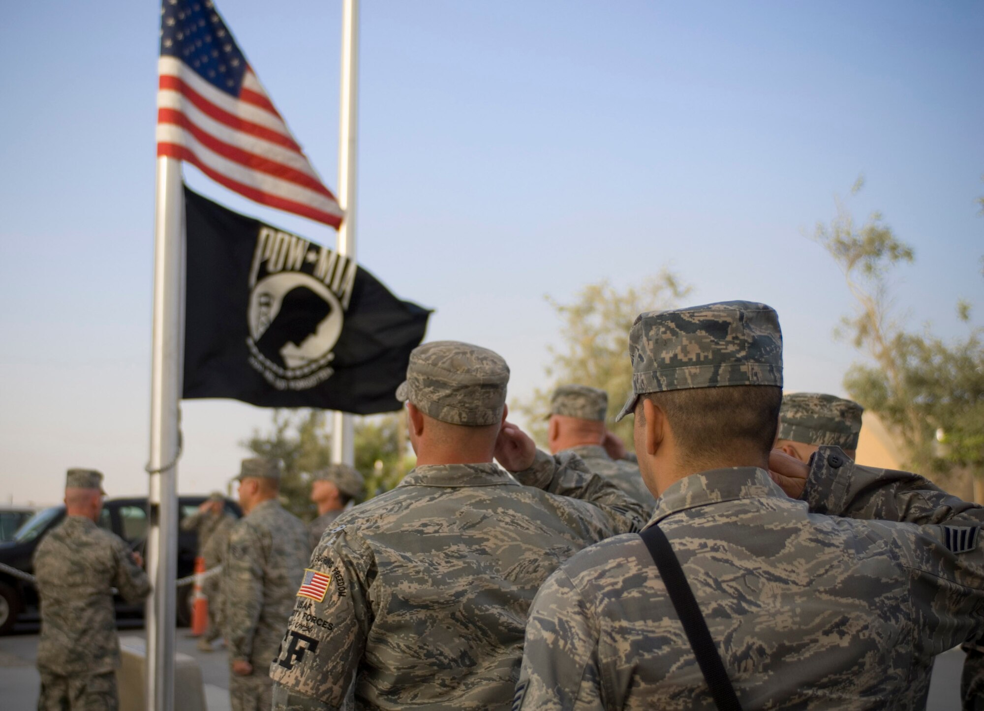 Airmen salute while the flag is lowered during a POW/MIA recognition ceremony at Bagram Air Field, Afghanistan, Sept. 19. The Air Force Sergeants Association?s first chapter in Afghanistan sponsored the event one week after becoming an officially recognized affiliate. AFSA Expeditionary Chapter 1657 is the second chapter to be established in a deployed location. (U.S. Air Force photo by Staff Sgt. Rachel Martinez/RELEASED)