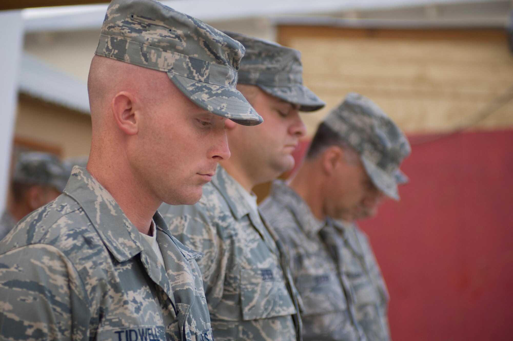 Tech. Sgt. Joshua Tidwell, 455th Expeditionary Logistics Readiness Squadron, and members of the flag-folding detail, pause during a moment of silence to honor U.S. servicemembers who have gone missing in action during the POW/MIA recognition ceremony at Bagram Air Field, Afghanistan, Sept. 19. The ceremony was organized by the first Air Force Sergeants Association Chapter in Afghanistan. (U.S. Air Force photo by Staff Sgt. Rachel Martinez/RELEASED)