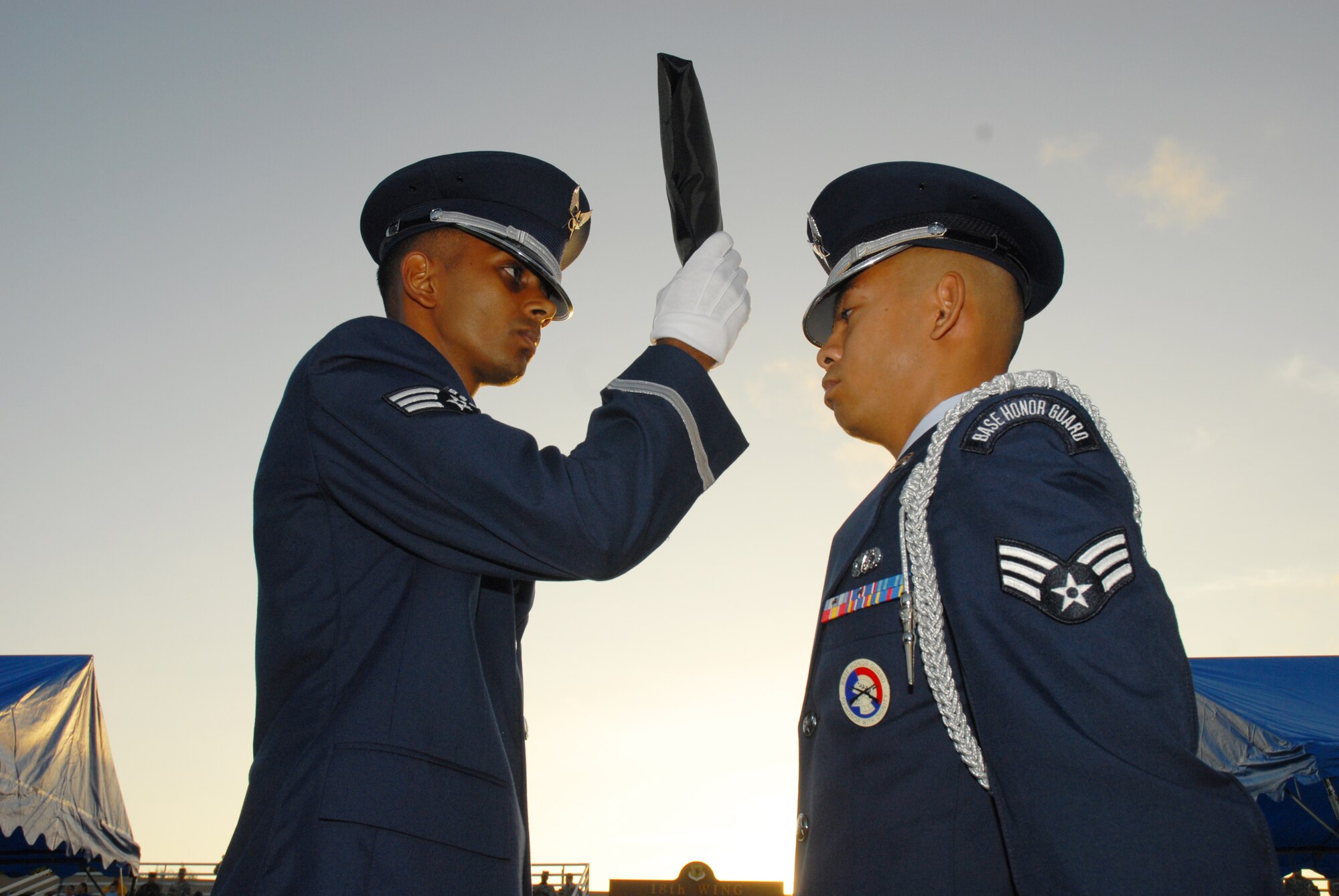 Senior Airman Aman Prasad passes the POW/MIA flag to Senior Airman Marlon Quitos of the Kadena Honor Guard during the annual POW/MIA Memorial Ceremony Sept. 19, 2008. Kadena Air Base hosts a remembrance ceremony each year in honor of all POW/MIA service members past and present. (U.S. Air Force photo/Airman 1st Class Chad Warren)