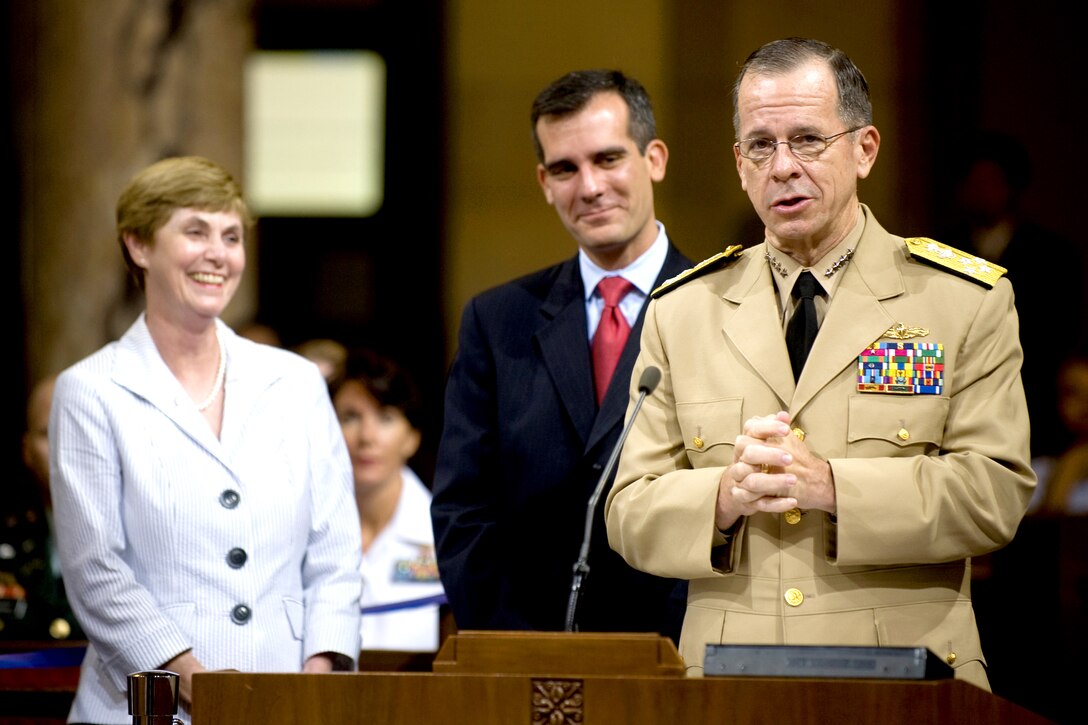 As Mrs. Deborah Mullen and Los Angeles City Councilman Eric Garcetti look on, Navy Adm. Mike Mullen, chairman of the Joint Chiefs of Staff, addresses the Los Angeles City Council, Sept. 19, 2008. Mullen, a native of Los Angeles, was honored by the representatives for his more than 40-years of service to his country. 