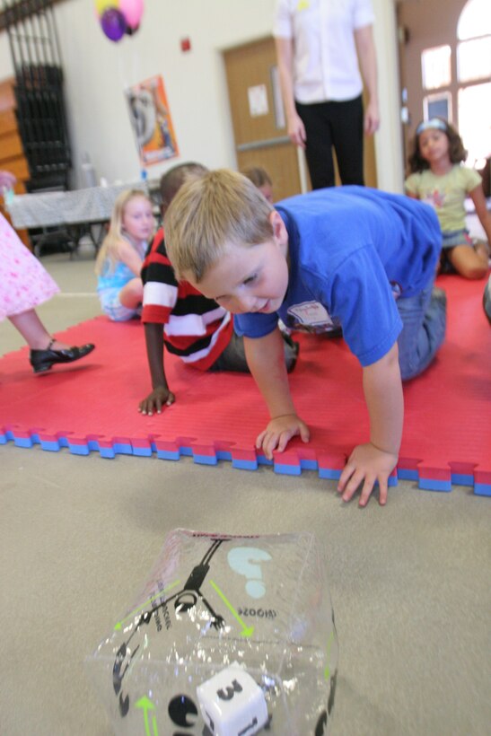 Dylan M. Swazee, 5, chases after the dice being used to express how you feel during a Marine Corps Family Team Building exercise at the San onofre Community Center.