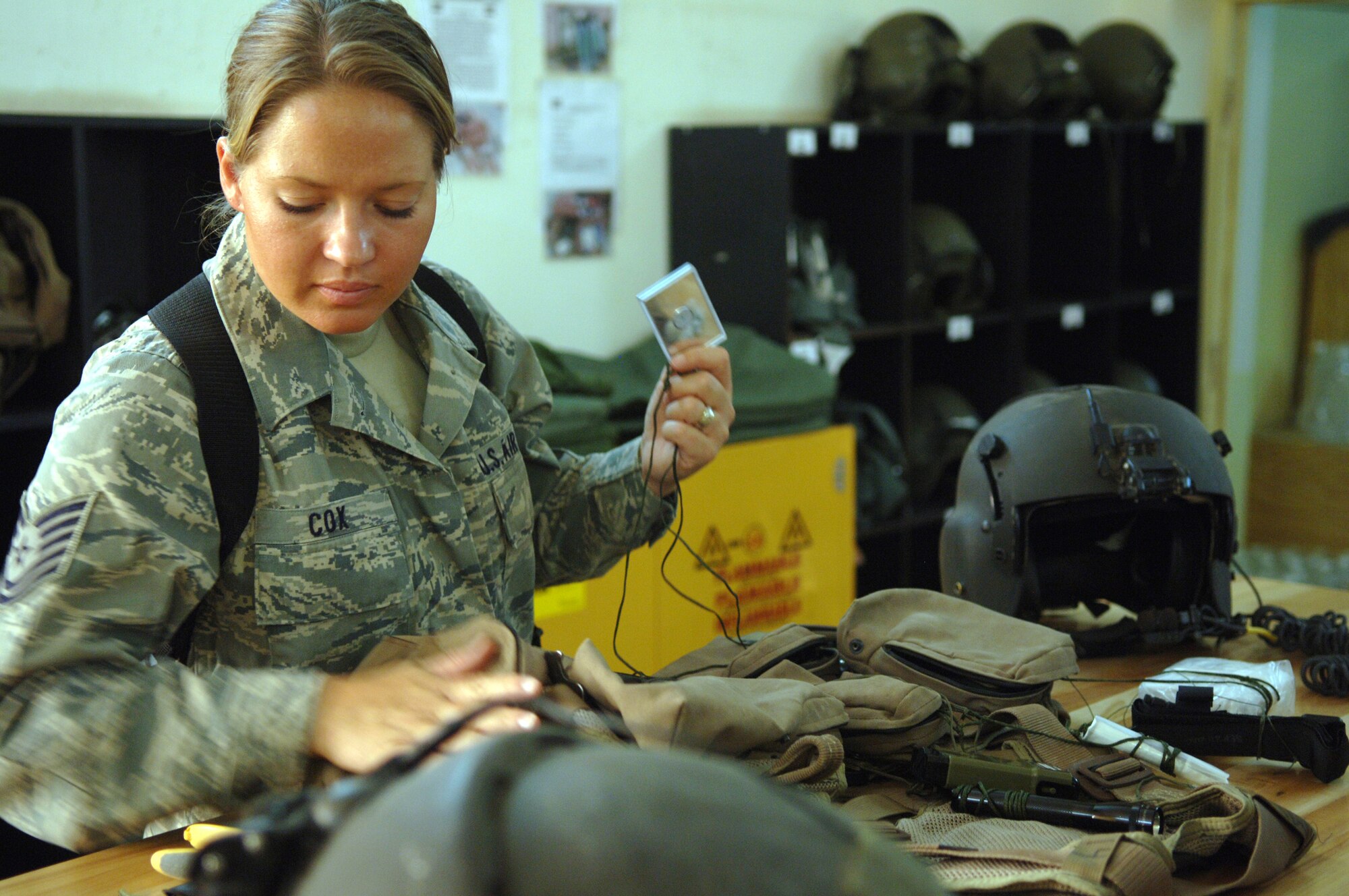 Tech. Sgt. Shaun Cox inspects an Iraqi air force life support vest before a night operations training mission at Taji Air Base, Iraq, Sept. 11. The life support vests contain GPS navigation aids and basic survival equipment designed to help aircrews stay alive and evade the enemy if they are forced to make an emergency landing. Cox, a combat adviser for Iraqi air force flight equipment, is deployed to the 770th Air Expeditionary Advisory squadron from Luke Air Force Base, Ariz. Her hometown is Lincoln, Neb. (U.S. Air Force photo/Staff Sgt. Don Branum)