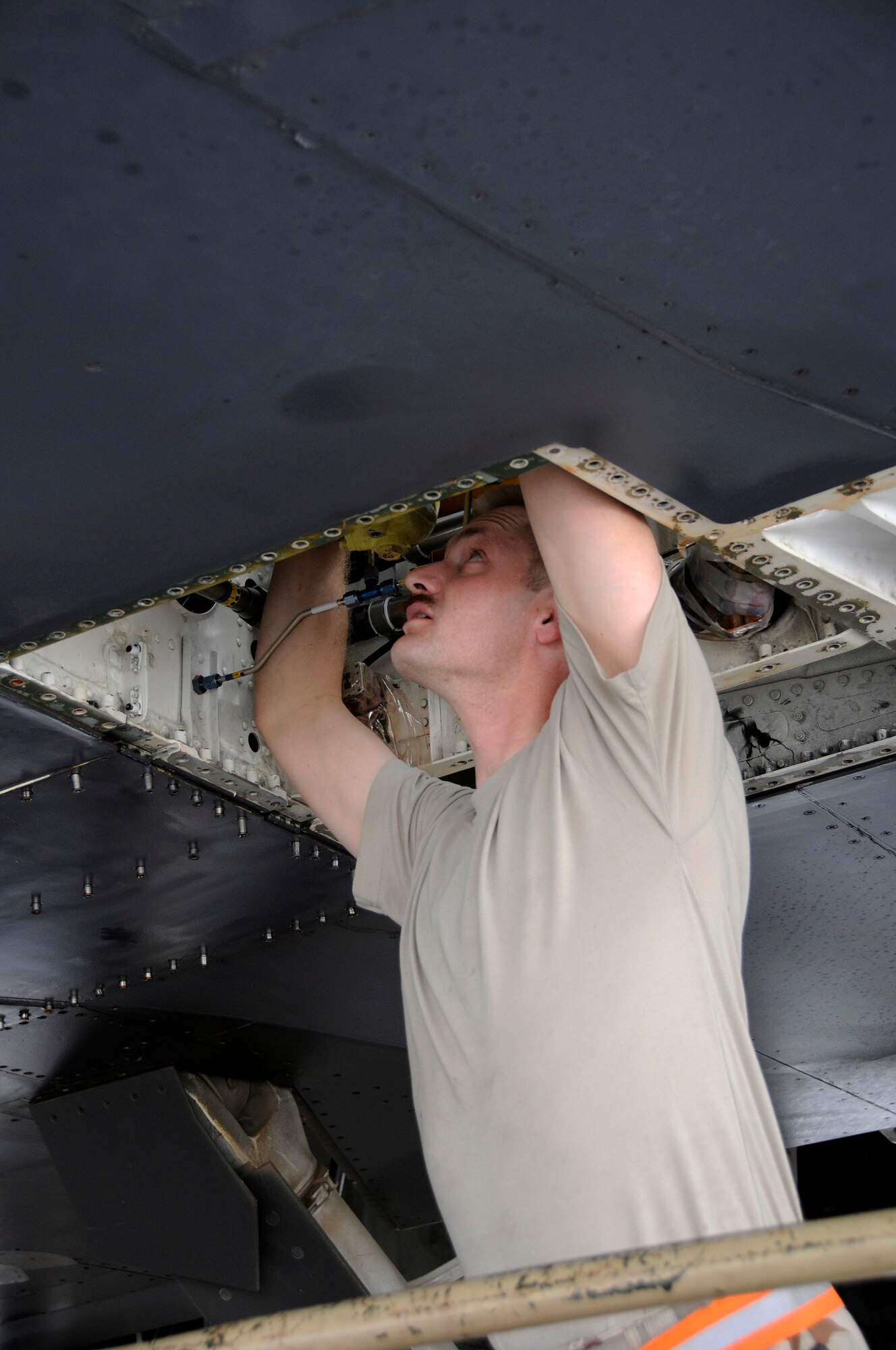 Tech. Sgt. Neil Cook, 379th Expeditionary Aircraft Maintenance Squadron, 34th Aircraft Maintenance Unit, works on a control valve located high above his head Sept. 19, 2008.  The working area is very tight making it difficult to keep two wrenches on the valve, when changing the wing sweep gear sub-assembly on the B-1 Lancer here at this undisclosed location in Southwest Asia.  The B-1 is the backbone of America's long-range bomber force. It can rapidly deliver massive quantities of precision and non-precision weapons against any adversary, anywhere in the world, at any time.  Sergeant Cook is a native of Rapid City, S.D., and deployed from Ellsworth Air Force Base, S. D., in support of Operations Iraqi and Enduring Freedom and Joint Task Force-Horn of Africa.  (U.S. Air Force photo by Tech. Sgt. Michael Boquette/Released)
