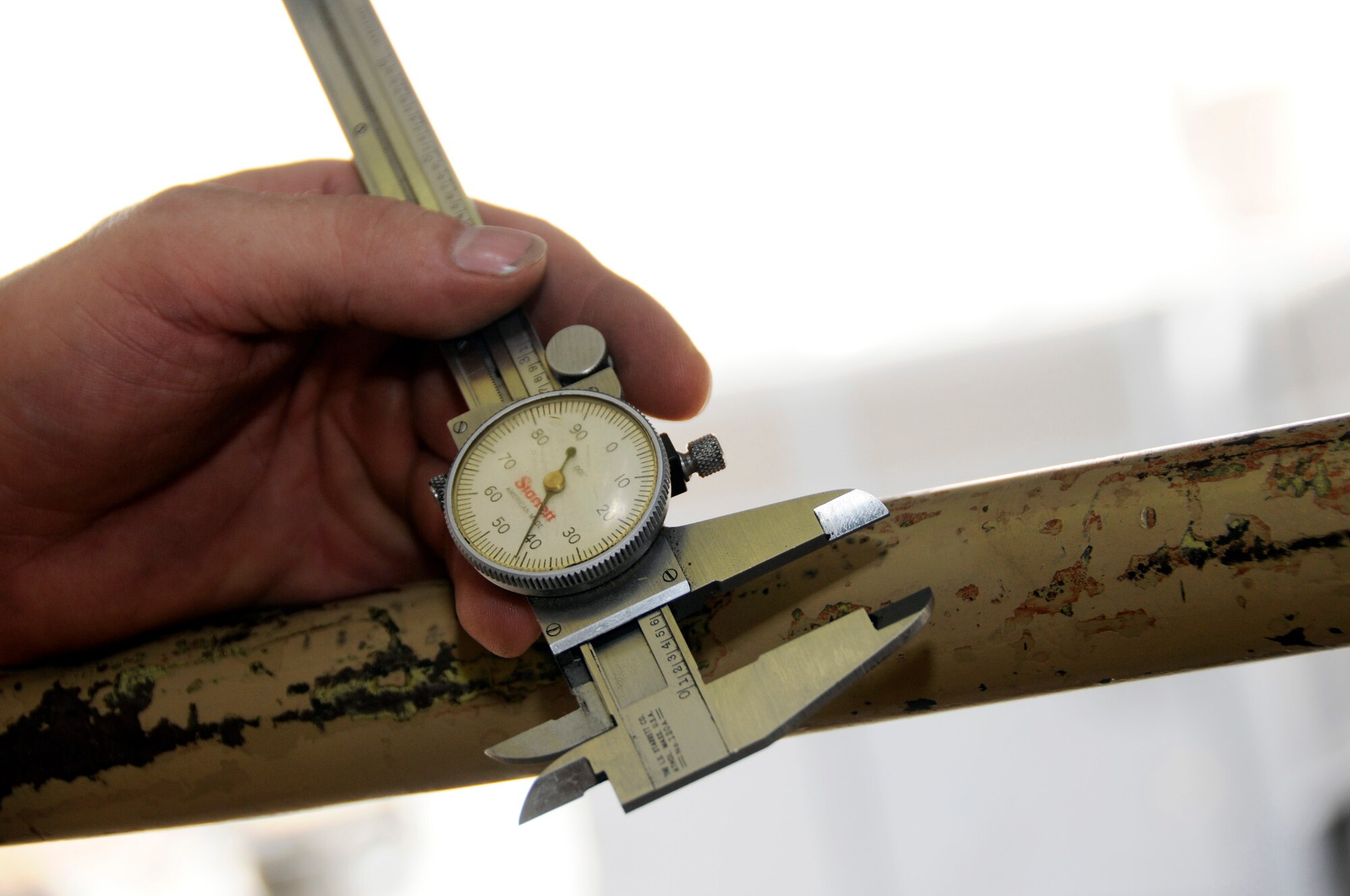Tech. Sgt. Neil Cook, 379th Expeditionary Aircraft Maintenance Squadron, 34th Aircraft Maintenance Unit, uses calipers to check tolerance on a control valve Sept. 19, 2008.  The tolerance adjustment on the control valve is tight, at 3/1000 of an inch, when changing the wing sweep gear sub-assembly on the B-1 Lancer here at this undisclosed location in Southwest Asia.  The B-1 is the backbone of America's long-range bomber force. It can rapidly deliver massive quantities of precision and non-precision weapons against any adversary, anywhere in the world, at any time.  Sergeant Cook is a native of Rapid City, S.D., and deployed from Ellsworth Air Force Base, S. D., in support of Operations Iraqi and Enduring Freedom and Joint Task Force-Horn of Africa.  (U.S. Air Force photo by Tech. Sgt. Michael Boquette/Released)