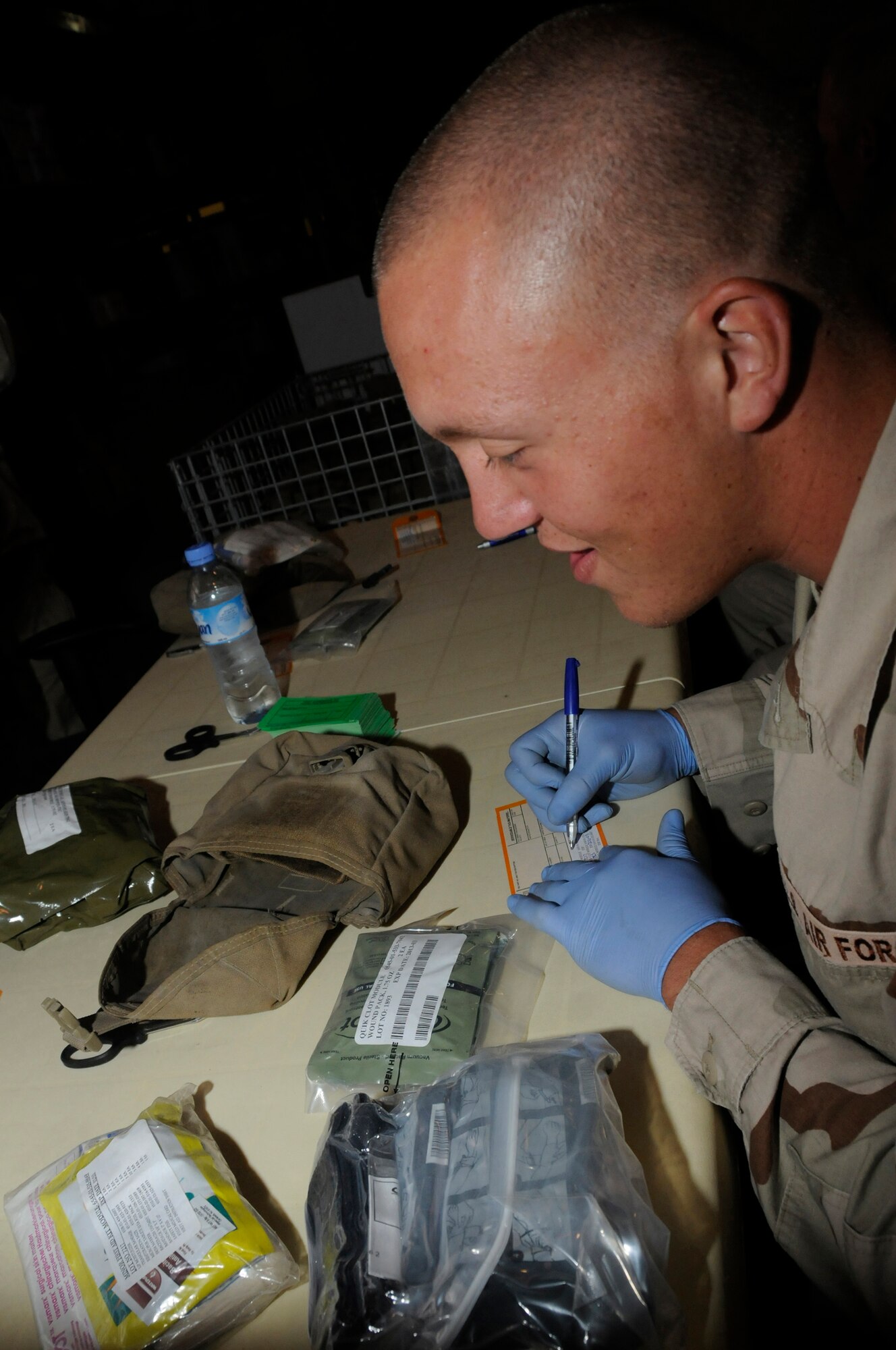 Airman 1st Class Matthew Lawrence, pavement and equipment operator assigned to the 379th Expeditionary Civil Engineer Squadron, completes a serviceable tag with expiration dates and lot numbers of the trauma, minor and Quik Clot modules to attach to an individual first aid kit Sept. 19, 2008, at an undisclosed air base in Southwest Asia. Once a week, volunteers recertify about 1,200 IFAKs to make sure the items inside are current so they can be used in the U.S. Central Command area of responsibility. Airman Lawrence, a native of Richmond, Va., is deployed from Grand Forks Air Force Base, N.D., supporting Operations Iraqi Freedom, Enduring Freedom and Joint Task Force-Horn of Africa. (U.S. Air Force photo by Staff Sgt. Darnell T. Cannady/Released)