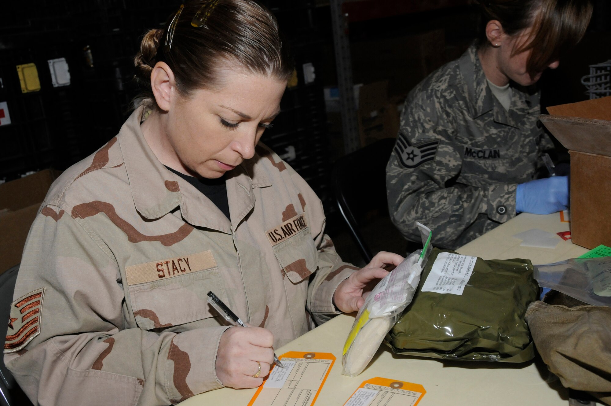 Tech. Sgt. Teresa Stacy, contracting officer assigned to the 379th Expeditionary Contracting Squadron, fills out serviceable tags with expiration dates and lot numbers of modules for individual first aid kits Sept. 19, 2008, at an undisclosed air base in Southwest Asia. Once a week volunteers recertify about 1,200 IFAKs to make sure the items inside are current so they can be used in the U.S. Central Command area of responsibility. Sergeant Stacy, a native of Colorado Springs, Colo., is deployed from Schriever Air Force Base, Colo., supporting Operations Iraqi Freedom, Enduring Freedom and Joint Task Force-Horn of Africa. (U.S. Air Force photo by Staff Sgt. Darnell T. Cannady/Released)