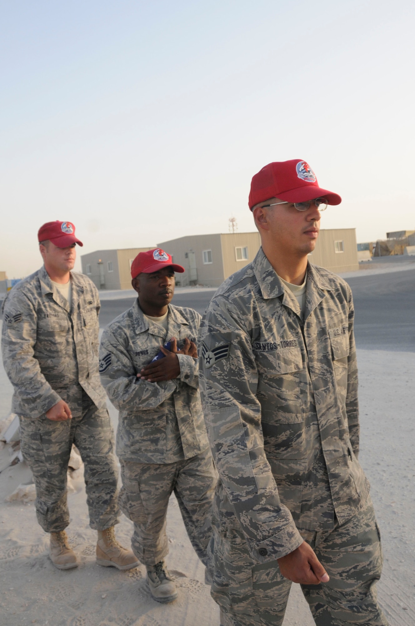 Senior Airman Antonio Santos-Torres, front, Staff Sgt. LaCourtney Jones, middle, and Senior Airman Jason Freytag, last, carry the U.S. flag inside after performing retreat Sept. 19, 2008, at an undisclosed air base in Southwest Asia. Airman Santos-Torres is a native of Ponce, Puerto Rico. Airman Freytag is a native of Temple, Texas and Sergeant Jones is a native of Augusta, Ga. All three are supply personnel assigned to the 1st Expeditionary RED HORSE Group deployed in support of Operations Iraqi Freedom, Enduring Freedom and Joint Task Force-Horn of Africa from Hurlburt Field, Fla.  Everyday the RED HORSE Group raises and lowers the flag in front of their compound for reveille and retreat. (U.S. Air Force photo by Staff Sgt. Darnell T. Cannady/Released)