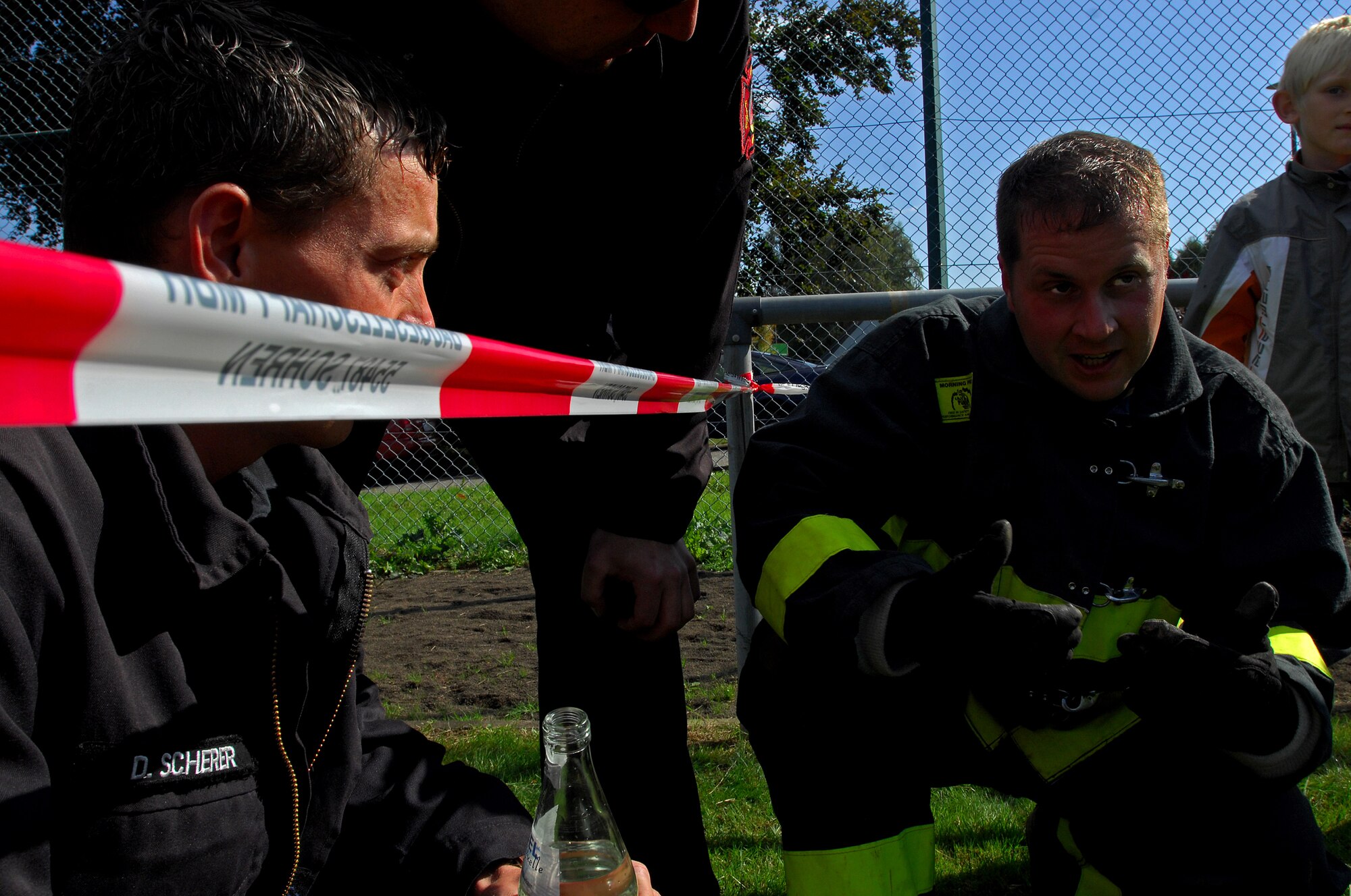 Daniel Scherer (left) and Steffen Schunck (right), 835th Civil Engineer Squadron Fire Department take a rest in between scenarios during the Firefighters Challenge 2008, Buchenbeuren, Germany, Sept. 14, 2008. Firefighters from over 40 different stations came together to compete in fire protection scenarios during the challenge. (U.S. Air Force photo Airman 1st Class Kenny Holston)(Released)*