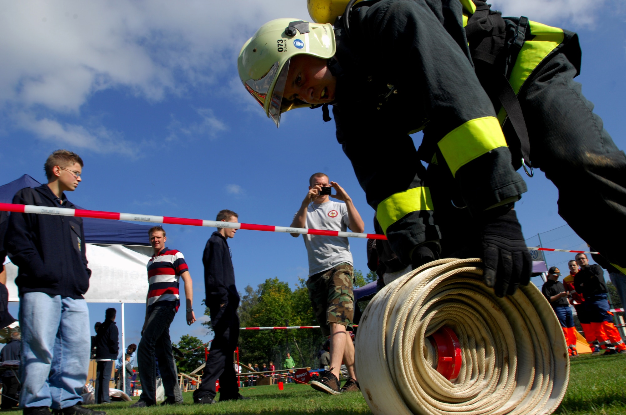 Steffen Schunck, 835th Civil Engineer Squadron Fire Department, coils a fire hose as the final objective of the 'hose drag' scenario during the Firefighters Challenge 2008, Buchenbeuren, Germany, Sept. 14, 2008. Firefighters from over 40 different stations came together to compete in fire protection scenarios during the challenge. (U.S. Air Force photo Airman 1st Class Kenny Holston)(Released)*