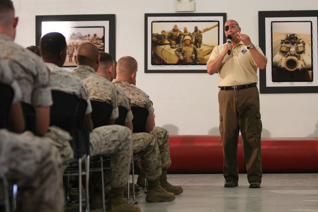 Retired Gunnery Sgt. Nicholas A Popaditch speaks to the Marines and sailors of 1st Tank Battalion in the battalion’s classroom Sept. 22. Popaditch, a Silver Star recipient for actions displayed during a battle for Fallujah, Iraq in April 2005, while attached to 2nd Battalion, 1st Marine Regiment, spoke about such Marine Corps values as honor, courage and commitment, as well as training and leadership. When talking about these topics Popadtich turned to personal experiences and advice that had been handed down to him over the years by senior Marines.