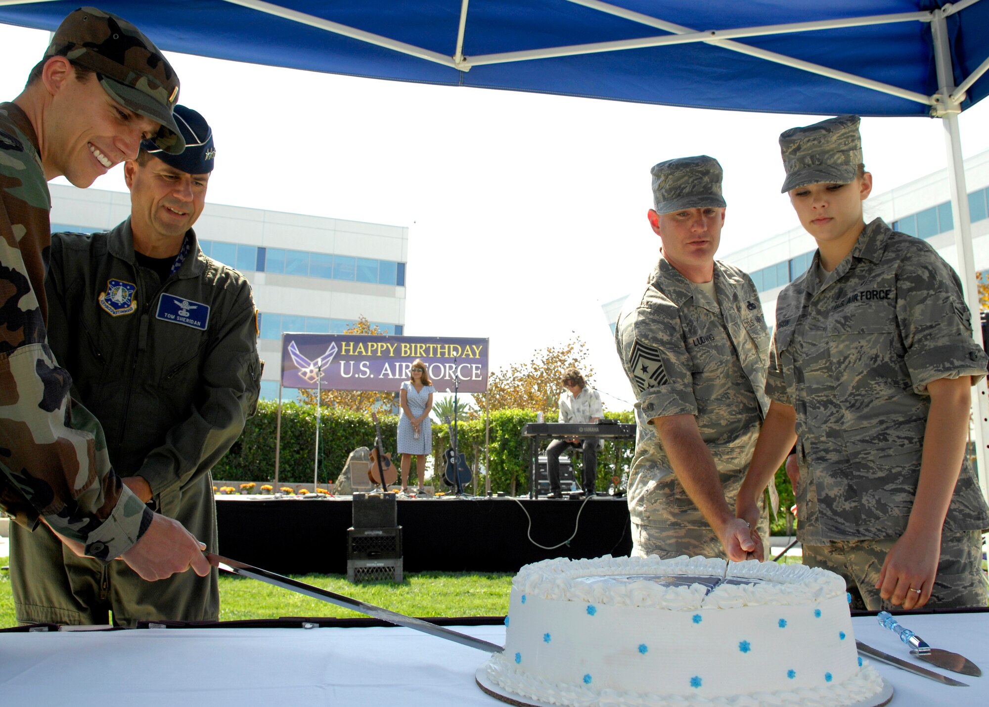 (left to right) The youngest officer on base 2nd Lt Travis Wittick, Space and Missile Systems Center commander Lt. Gen. Tom Scheridan, Command Chief Master Sergeant Chief Stephen Ludwig, and the youngest Airman on base Airman 1st Class Linsy Ellison from the 61st Medical Group, cut the Air Force birthday cake together in the Schriever Space Complex courtyard, Sep. 18. (Photos by Stephen Schester)