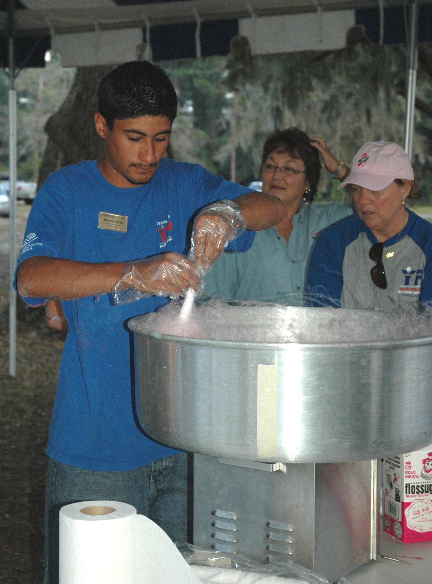 Michael Soto, Tyndall Youth Programs recreation assistant, creates cotton candy for a line of hungry guests at the years annual Oktoberfest held Friday evening.  More than 700 people came to celebrate the event.