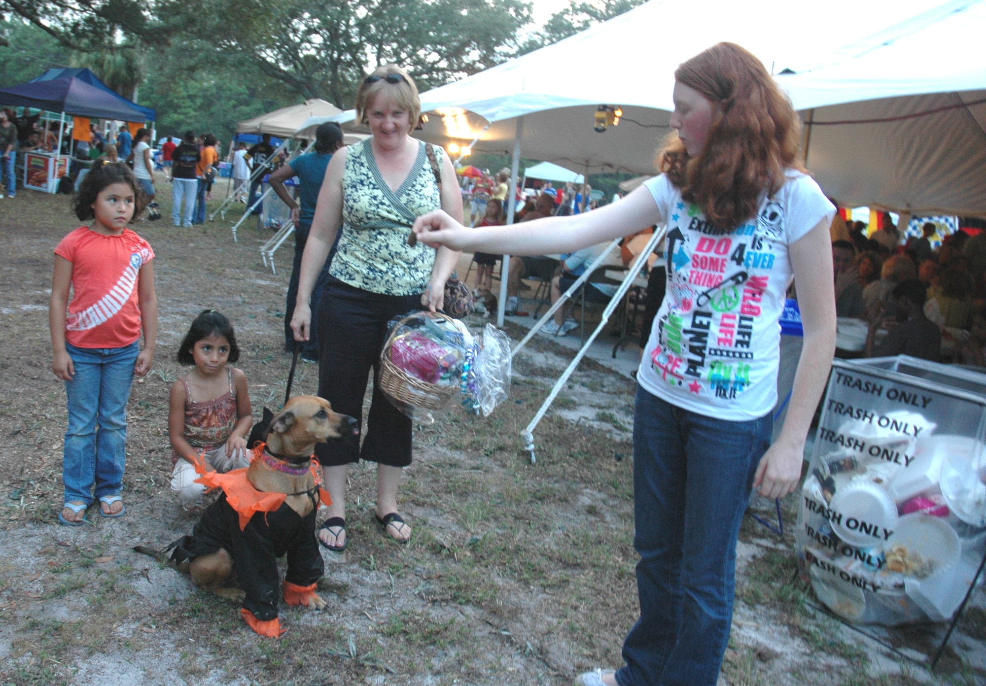Lucy, Kimberly and Paula Farley stand behind their prize winning dog Daisy while Hannah Farley rewards the pet with a dog treat.  The 'dog-strutt' was one of the many activities held Friday evening at Tyndall’s annual Oktoberfest. 