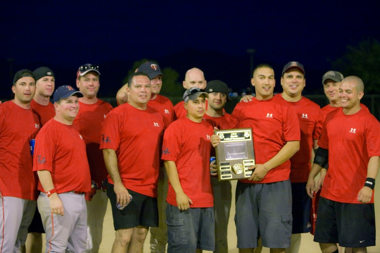 The 162nd Fighter Wing Engine Shop softball team poses for a photo with the JEC Softball Tournament plaque Sept. 20 at Lincoln Park. The team etched their name onto the plaque for winning the tournament's competitive finals. (Air National Guard photo by Tech. Sgt. Hollie Hansen)