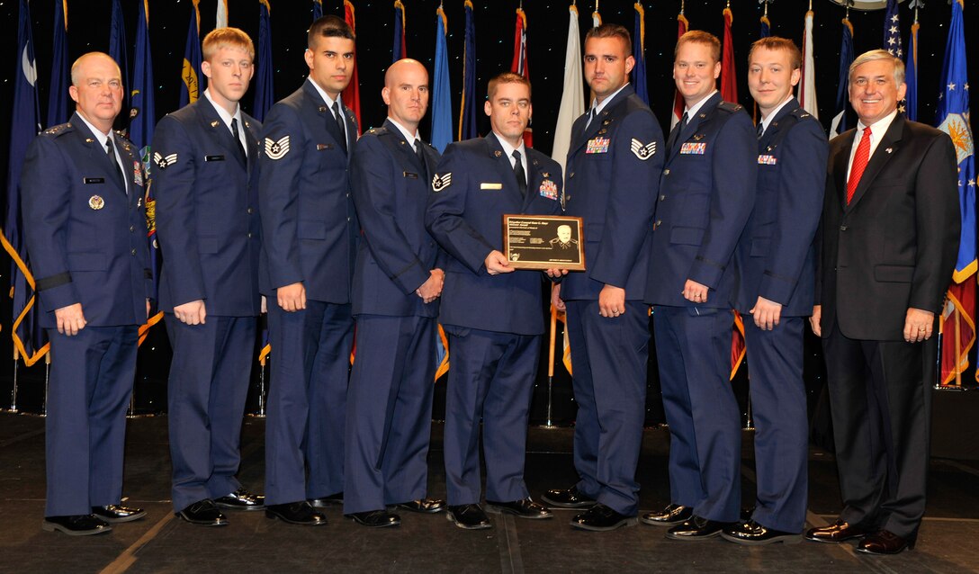 The crew of Woody 26 poses for a photo with AFSOC commander Lt. Gen. Donny Wurster (far left) and AFA Chairman Robert Largent (far right) after being awarded the Brigadier General Ross G. Hoyt Award at the Air Force Association's 2008 Air and Space Conference and Technology Exposition in Washington, D.C. recently. The Hoyt Award is awarded the best air refueling crew in the Air Force. Crew members are with the 67th Special Operations Squadron, 352nd Special Operations Group at RAF Mildenhall (U.S. Air Force photo by Michael Pausic).