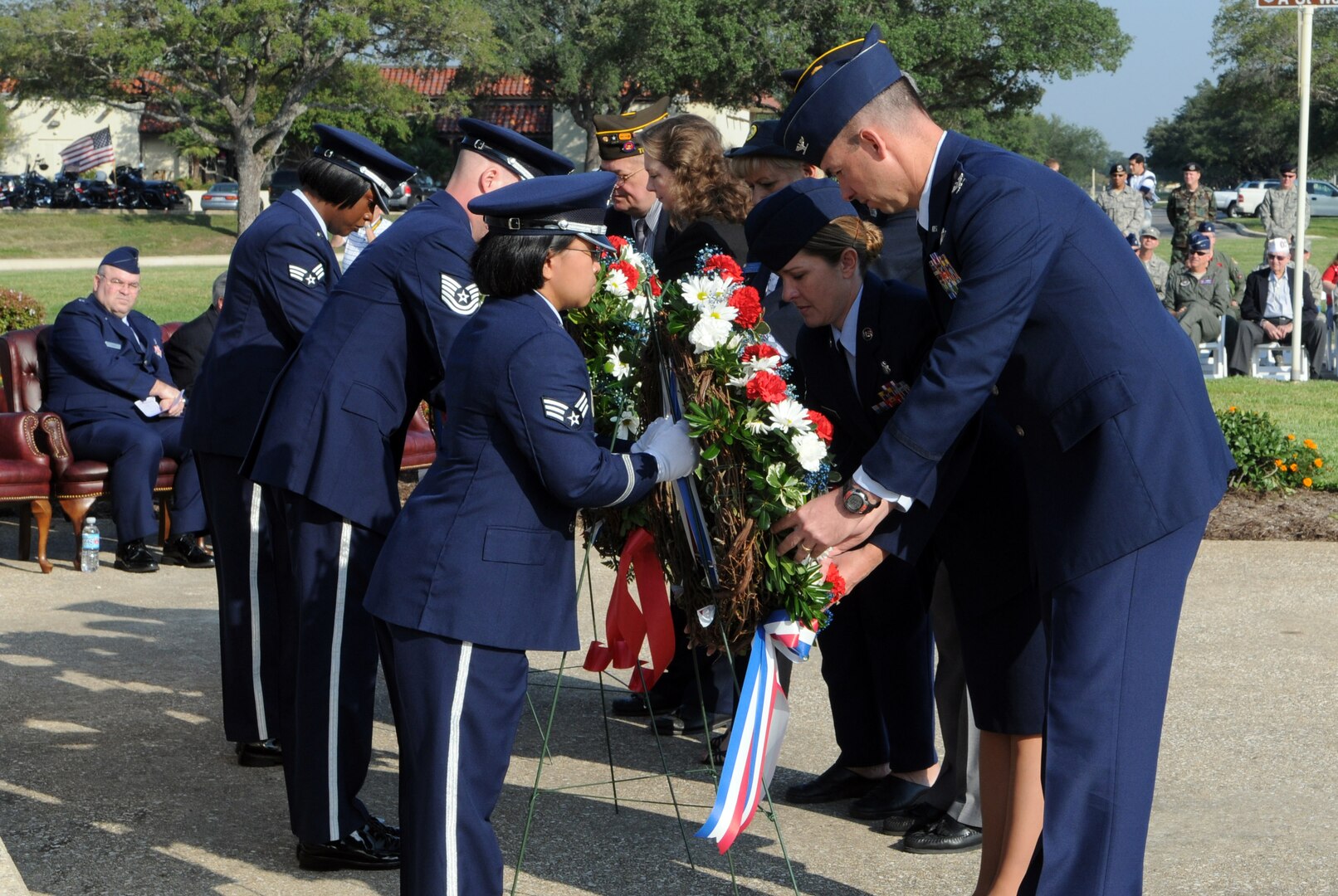 Col. Brian Killough (front, right), 12th Flying Training Wing vice commander, helps place a wreath during a POW/MIA remembrance ceremony Sept. 19. Team Randolph members joined veterans and local civic leaders in honoring prisoners of war and persons missing-in-action during a POW/MIA ceremony at the Missing Man Monument near Washington Circle. (U.S. Air Force photo by Don Lindsey)