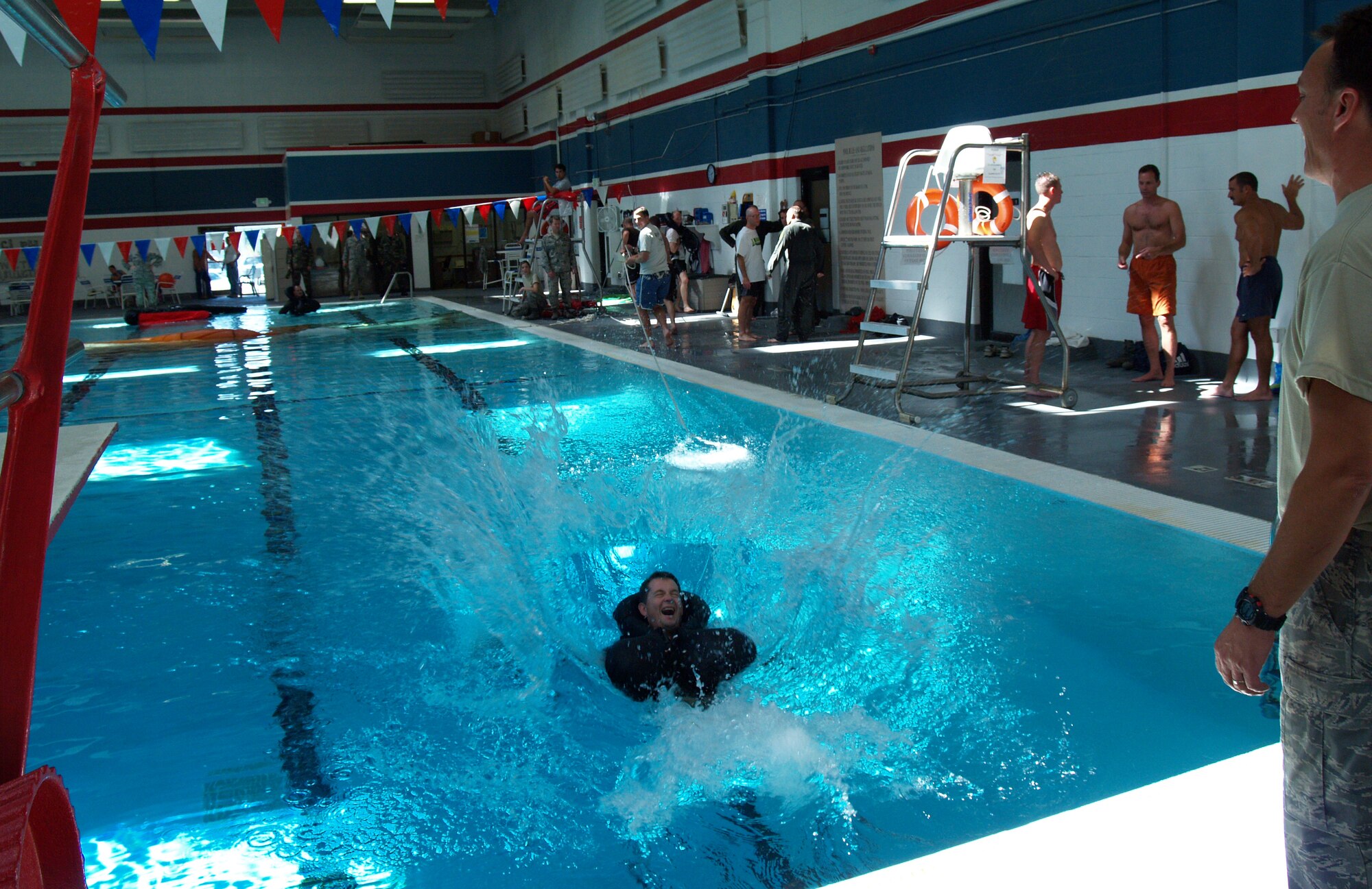 Members of the 466th Fighter Squadron receive their annual water survival training at the Hess Fitness Center pool during the September UTA.   Squadron members practiced landing in the water after a simulated ejection from their aircraft, learned how to escape from underneath a parachute, and were instructed how to use a life raft. (U.S. Air Force photo/Senior Airman Brandon Craig)