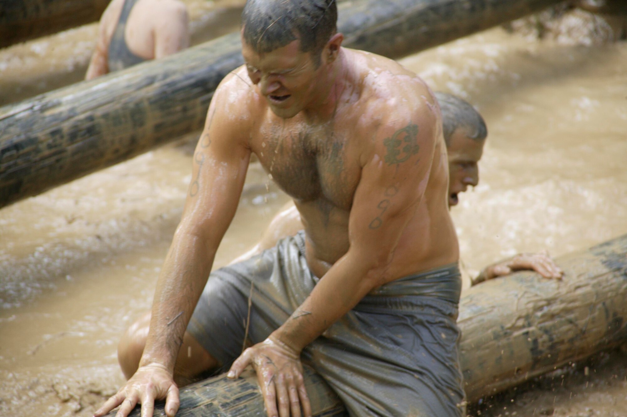 Eastover, S.C.-- Tech. Sgt. Scott Ackeret, Shaw Air Force Base Explosive Ordnance Disposal team member, tries to catch his breath through the mud as he maneuvers over a log obstacle in the 15th Annual U.S. Marine Corps Ultimate Challenge Mud Run at the USMC Reserve Center Sept. 20. The EOD team ran the 4.2 mile challenge in 50 minutes and 12 seconds, placing 101st out of approximately 1,200 teams and 9th out of the 53 military teams. (U.S. Air Force photo/Staff Sgt. Holly Brown)