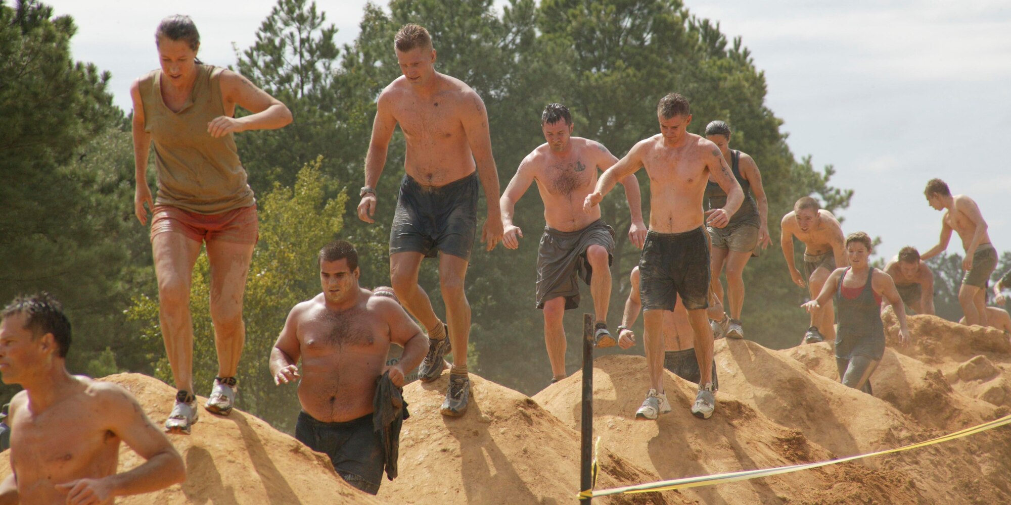 Eastover, S.C.-- Senior Master Sgt. Jason Hines, Tech. Sgt. Scott Ackeret, and Senior Airmen Michael Pasley and Trevor Brown, Shaw Air Force Base Explosive Ordnance Disposal team members, run over dirt mounds amongst fellow competitors at the 15th Annual U.S. Marine Corps Ultimate Challenge Mud Run at the USMC Reserve Center Sept. 20. The team ran the 4.2 mile challenge in 50 minutes and 12 seconds, placing 101st out of approximately 1,200 teams and 9th out of the 53 military teams. (U.S. Air Force photo/Staff Sgt. Holly Brown)