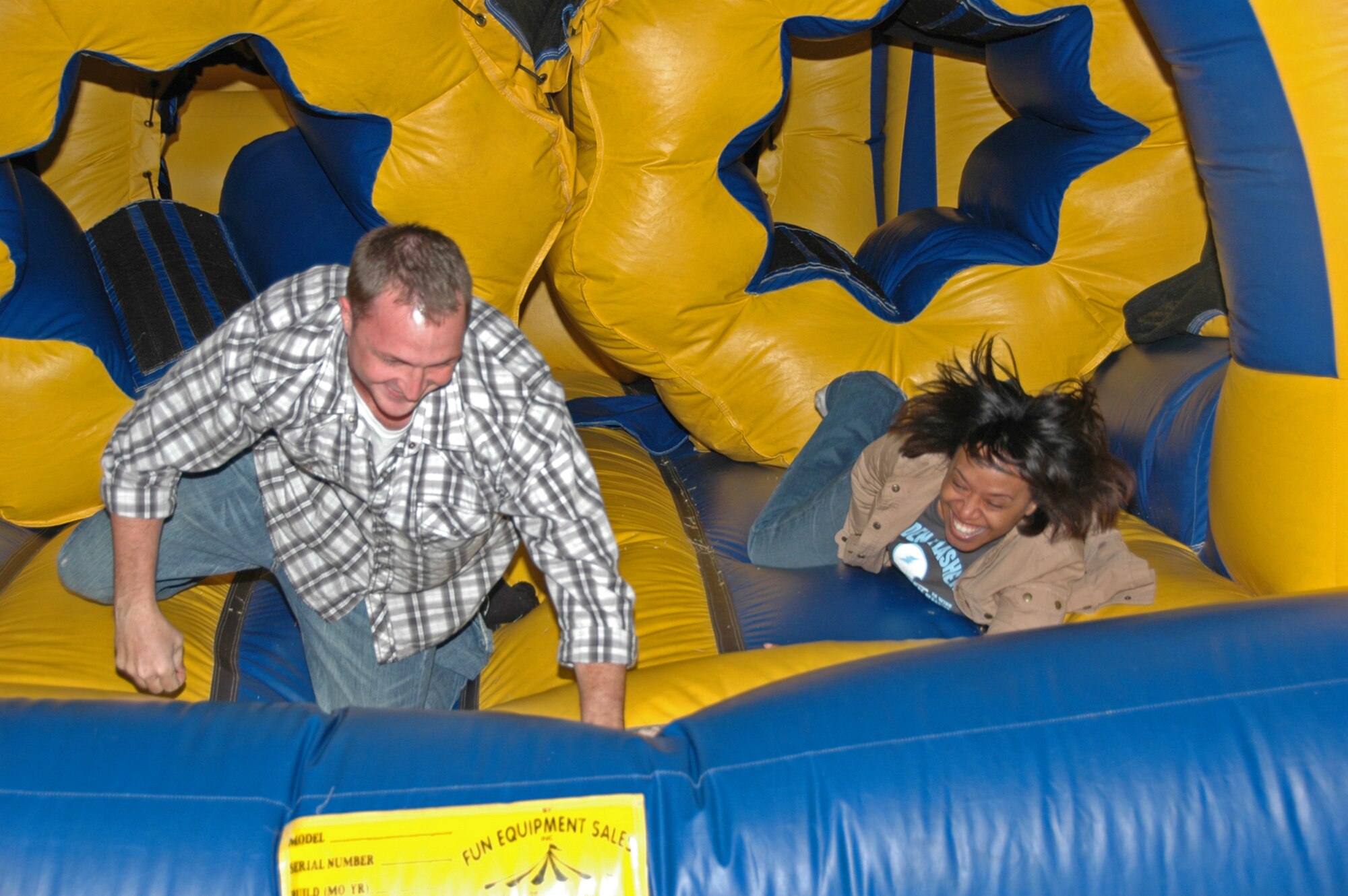 Staff Sgt. Wally Brannen and Senior Airman Tamara Wilson reach the finish of an inflatable obstacle course set up for old and young to enjoy during the 931st Air Refueling Group Family Day Picnic on Sept. 14. Both Airmen are assigned to the 931st Aerospace Medicine Flight. (U.S. Air Force photo/Senior Airman Connor Burkhard)