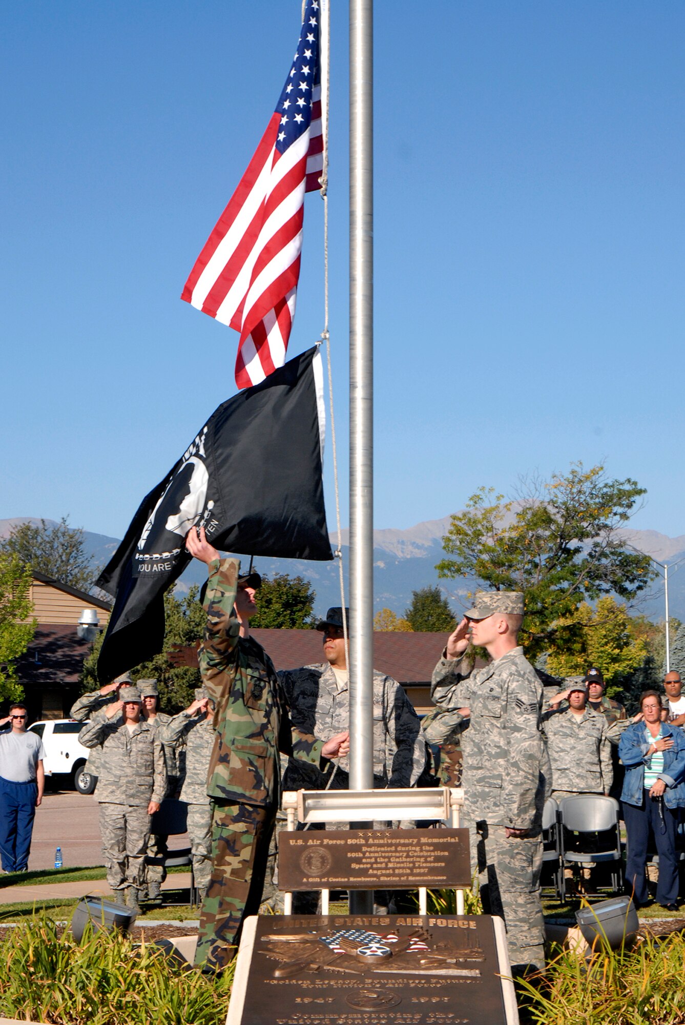 The American Flag and the POW/MIA Flag are lowered during the Sept. 18 retreat cermony at the Peterson Air Force Base Museum in Colorado. The event was used as a forum to inform personnel about POW/MIA Remembrance Week on the base, which ran Sept. 15-19. POW/MIA week allowed members of the installation to remember those held prisoner of war and those missing in action during times of conflict. (U.S. Air Force photo/Craig Denton)