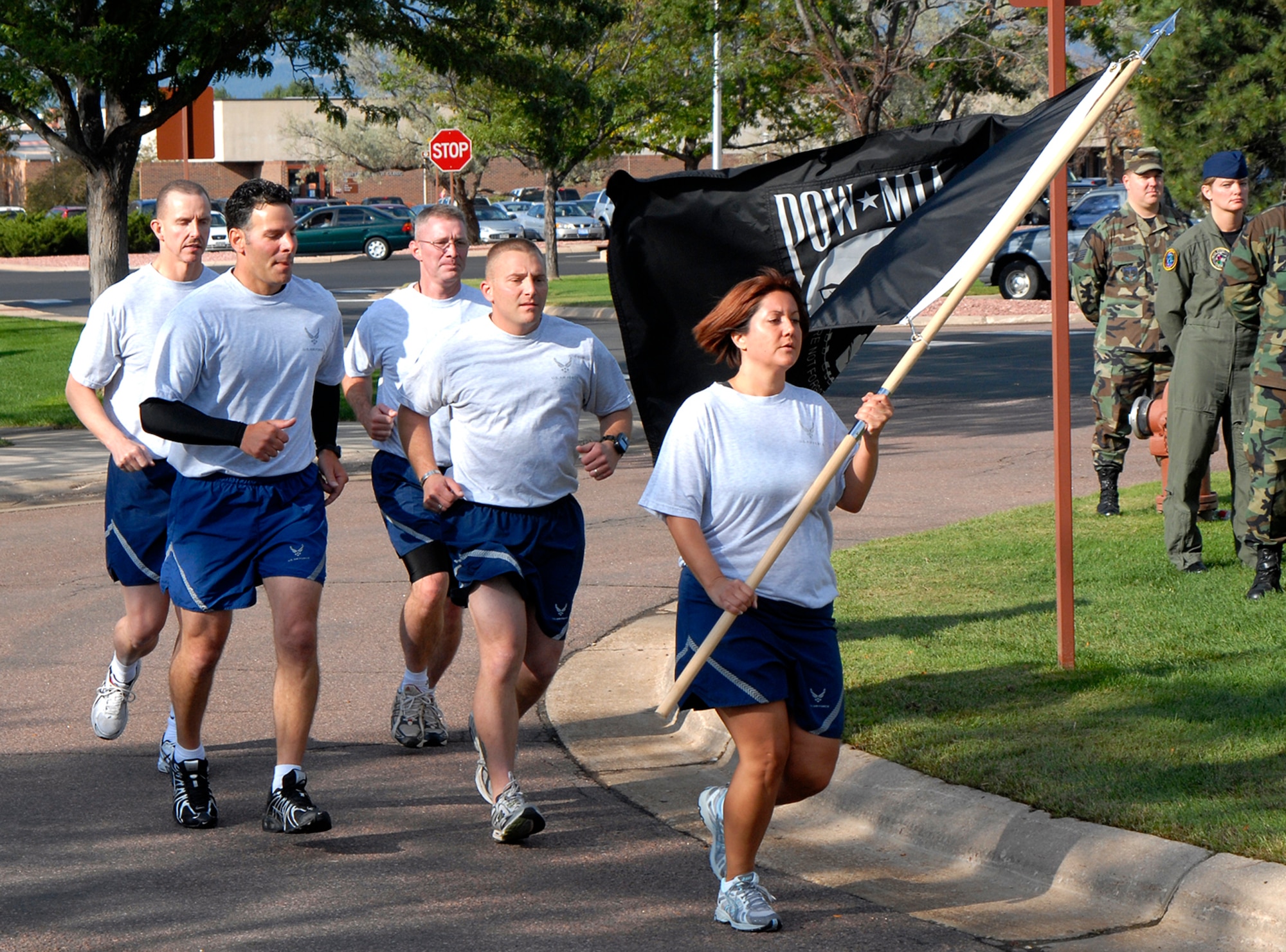The 24-hour POW/MIA memorial run ends Sept. 19 as personnel present the POW/MIA flag at the Remembrance Ceremony held at the Peterson Air Force Base Chapel. The event was used as a forum to inform personnel about POW/MIA Remembrance Week on the base, which ran Sept. 15-19. POW/MIA week allowed members of the installation to remember those held prisoner of war and those missing in action during times of conflict. (U.S. Air Force photo/Craig Denton)