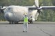 Murray King, Arnold AFB Airfield manager, directs the C-130 aircraft delivering the Little Rock AFB civic leaders. Inset, AEDC Commander Col. Art Huber welcomes Brig. Gen. Rowayne A. Schatz to Arnold. (Photo by Rick Goodfriend)