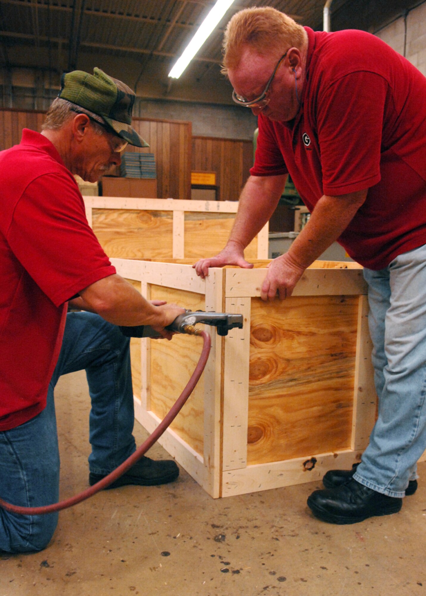 MOODY AIR FORCE BASE, Ga. – Steve Garren, 23rd Logistics Readiness Squadron wood worker, holds the sides of a crate together while Ken Lamoreaux, 23rd Logistics Readiness Squadron wood worker, nails them together here Sept. 15. One of Ken and Steve’s main job is to make weapons crates. (U.S. Air Force photo by Airman Joshua Green)  