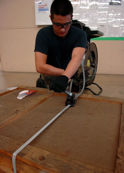 MOODY AIR FORCE BASE, Ga. – Airman 1st Class David Ivester, 23rd Logistics Readiness Squadron traffic management office apprentice, tightens a nylon string here Sept. 15., Airman Ivester seals the crate with three nylon strings.  (U.S. Air Force photo by Airman Joshua Green)  