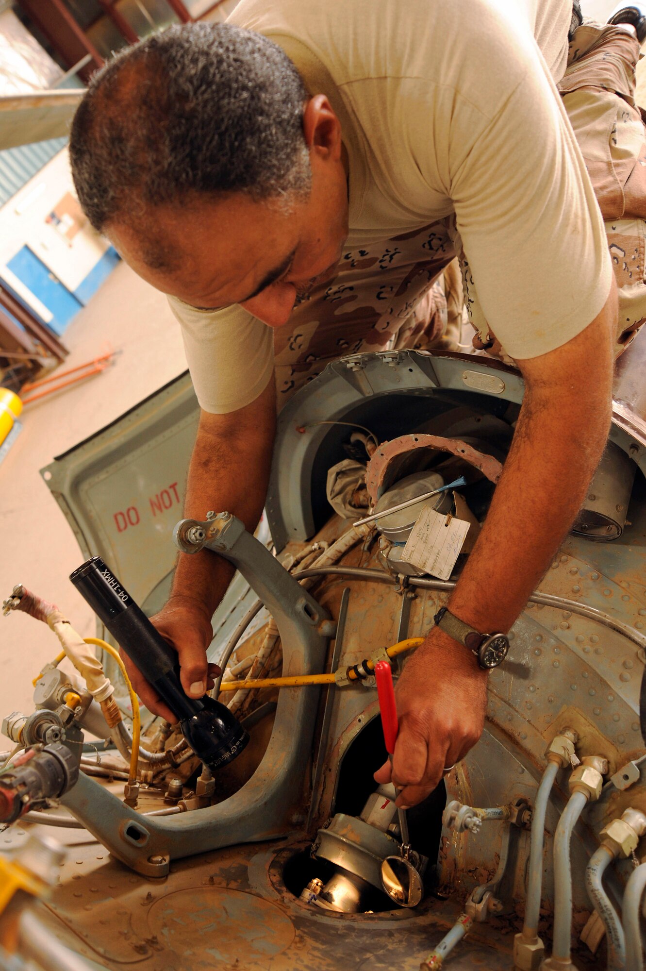 Iraqi air force Lt. Col. Auday Yasseu Yousif inspects a section of the tail rotor drive shaft of a Mi-17 Hip helicopter Sept. 11 at Al Taji Air Base, Iraq. The helicopter had made a hard landing and struck its tail skid against the ground, requiring a close inspection of its tail section. Colonel Yousif is chief engineer for Iraqi air force Squadron 4 second-line maintenance. (U.S. Air Force photo/Staff Sgt. Paul Villanueva II) 
