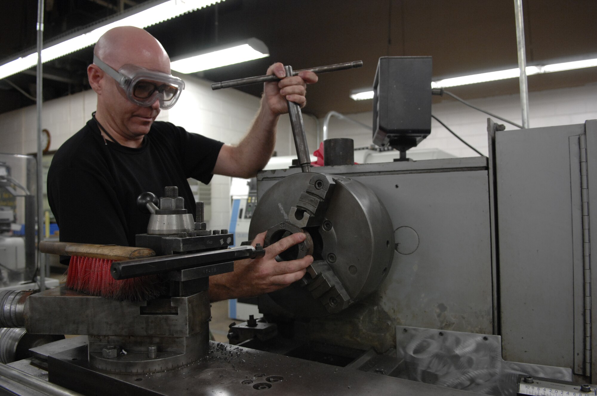 MOODY AIR FORCE BASE, Ga. -- Tech Sgt. David D. Huffman, 23rd Equipment Maintenance Squadron aircraft metals technology, uses a mill to modify a pipe cap here August 28. After completion of the widened cap grooves Sergeant Huffman cleans the area of debris and accounts for all tools used. (U.S. Air Force photo by Senior Airman Javier Cruz)