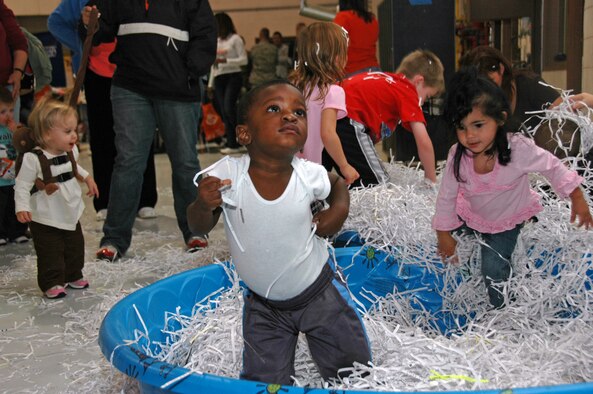 One-year old Jonathan Wilson (center) and 2-year old Ava Ringer (on right) enjoy a pool of shredded paper during the 931st Air Refueling Group Family Day Picnic in September.  Jonathan is the son of Tech. Sgt. Schavonne Wilson, 931st Headquarters Staff, and Ava is the daughter of Staff Sgt. Moni Ringer, 931st Military Support Flight.  Watching on the left is Brooklyn Stauf, 1-year-old daughter of Airman 1st Class Amanda Stauf, 931st Aerospace Medicine Squadron.  (U.S. Air Force photo/Senior Airman Connor Burkhard)