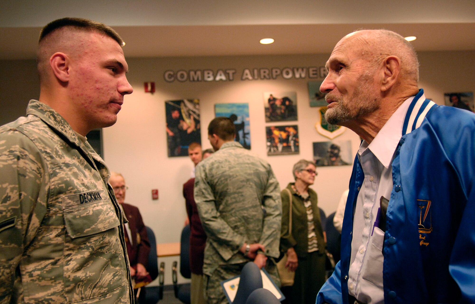LANGLEY AIR FORCE BASE, Va. -- Airman Vincent Deckman, from the 1st Aircraft Maintenance Squadron, is congratulated by Mr. Jim Ashley upon his graduation from the first term airmen center on Sept. 19. Mr. Ashley, a second lieutenant in the Army Air Corps during World War II and a prisoner of war for four months, was touring the base with fellow POWs during special activities for POW/MIA Recognition Day. (U.S. Air Force photo/Airman Rebecca Montez)
