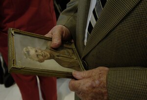 LANGLEY AIR FORCE BASE, Va.-- Mr. Mike McCarthy, an Army staff sergeant from World War II, holds an old picture of himself as he attends special ceremonies honoring POW/MIA Recognition Day Sept. 19. Mr. McCarthy was captured in September 1944 in Italy during the Brenner Pass offensive. (U.S. Air Force photo/Airman Rebecca Montez)