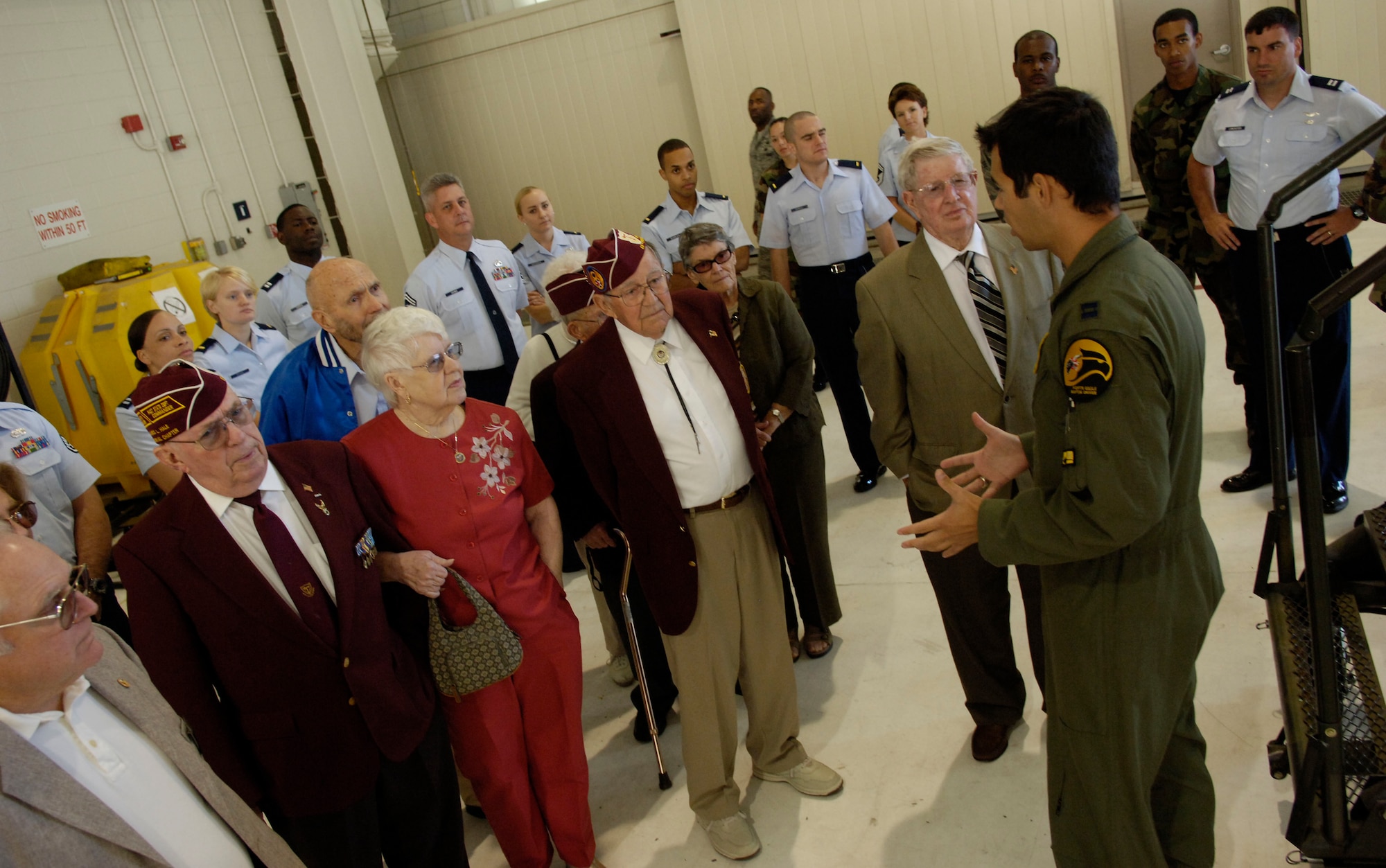 LANGLEY AIR FORCE BASE, Va. -- Capt. Michael Trujillo, 27th Fighter Squadron, explains features of the F-22 Raptor to former prisoners of war and their families during a special visit Sept.19 honoring POW/MIA Recognition Day. The POWs spent anywhere from two months to six and a half years in captivity during World War II and the Korean and Vietnam wars. (U.S. Air Force photo/Airman Rebecca Montez)