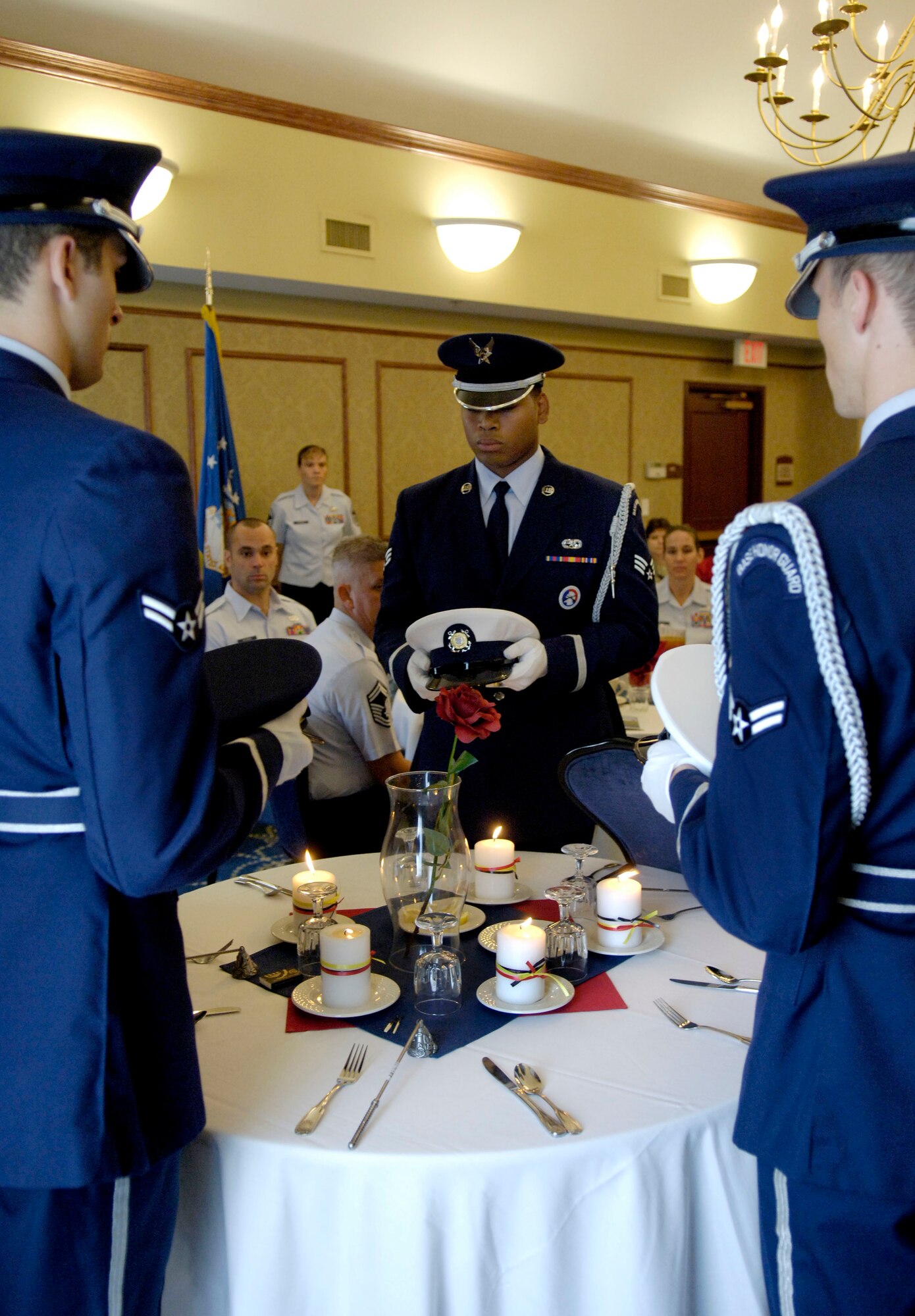 LANGLEY AIR FORCE BASE, Va. -- Members of the base honor guard perform a POW/MIA ceremony at the Bayside Enlisted Club Sept. 19 honoring POW/MIA Recognition Day. Langley Airmen were invited to attend a special luncheon in honor of visiting former prisoners of war from World War II and the Korean and Vietnam wars. (U.S. Air Force photo/Airman Rebecca Montez)