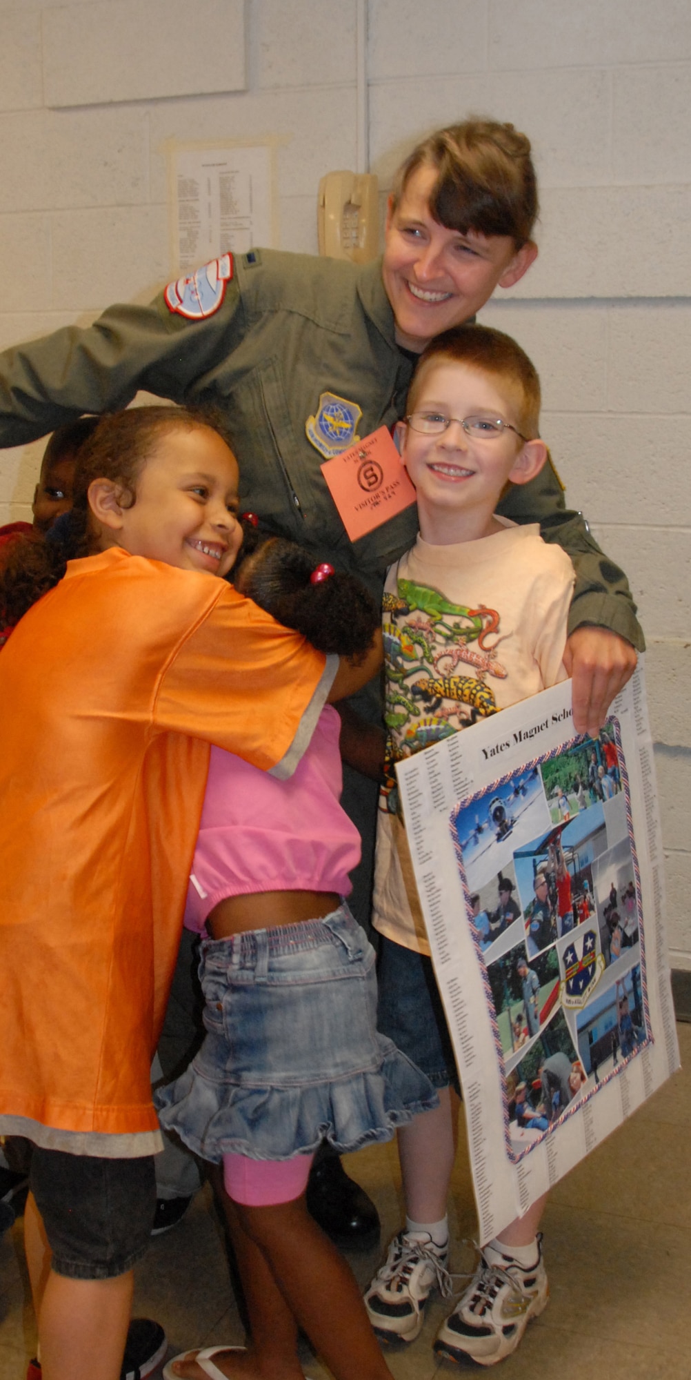 First Lt. Kelly Williams gets a group hug from students at Yates Elementary School. The school presented the volunteers with gifts and lunch to say thank you for all the work they've done. (U.S. Air Foce photo by Master Sgt. Christine Wood)