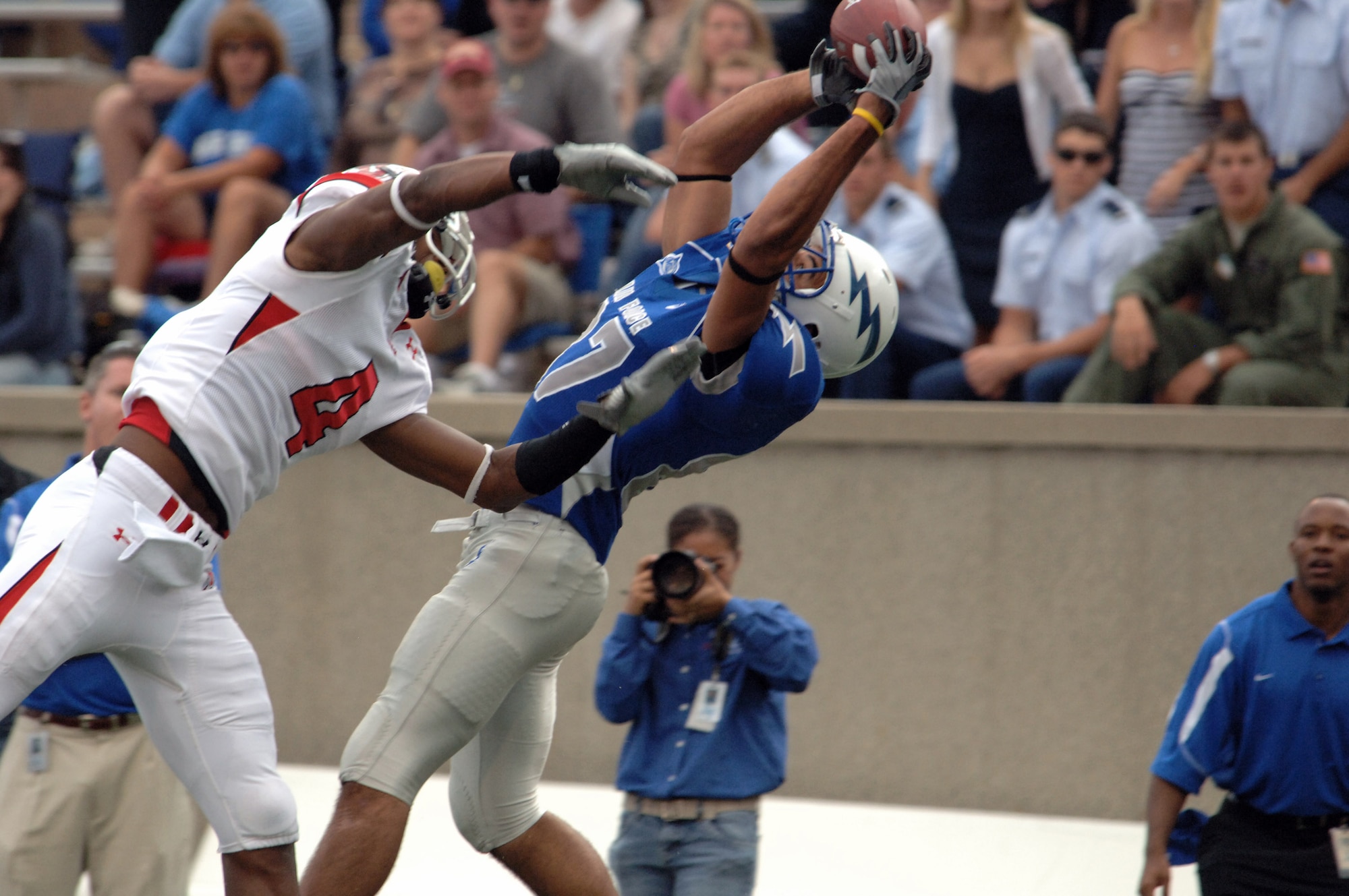 U.S. Air Force Academy wide receiver Josh Cousins stretches to haul in a 29-yard gain over Utah cornerback Sean Smith, moving the sticks to the Utah 2-yard-line and setting up Air Force's last score Sept. 20 at the Academy in Colorado. (U.S. Air Force photo/John Van Winkle) 

