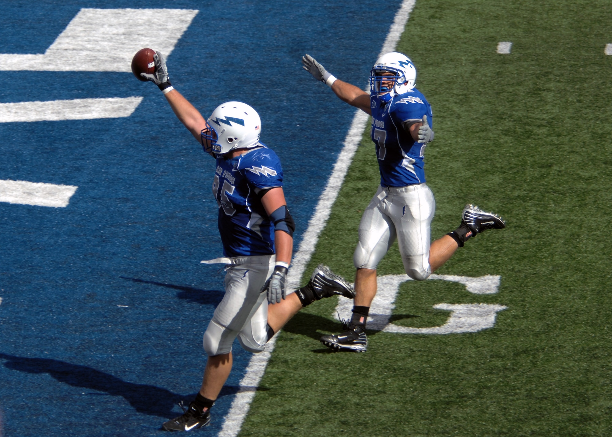 U.S. Air Force Academy senior defensive end Jake Paulson crosses the goal line after a fumble recovery, escorted by Falcon linebacker Ken Lamendola Sept. 20 at the Academy in Colorado. Going into the Utah game, Paulson led the nation in sacks with six this season. (U.S. Air Force photo/John Van Winkle) 
