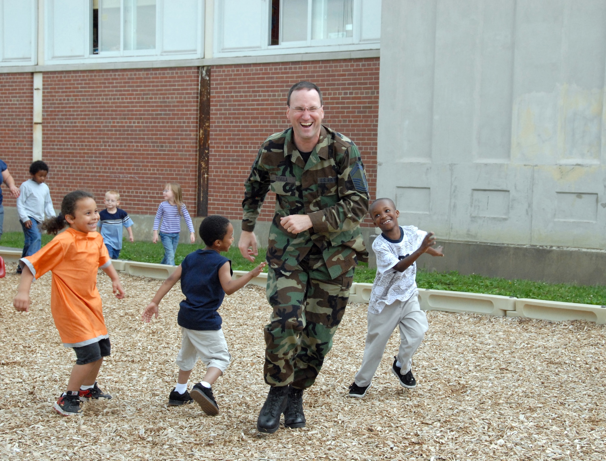 Senior Master Sgt. Christopher Tymula is chased by students as he volunteers his time to spend with students at Yates Elementary School in Schenectady. (U.S. Air Foce photo by Master Sgt. Christine Wood)