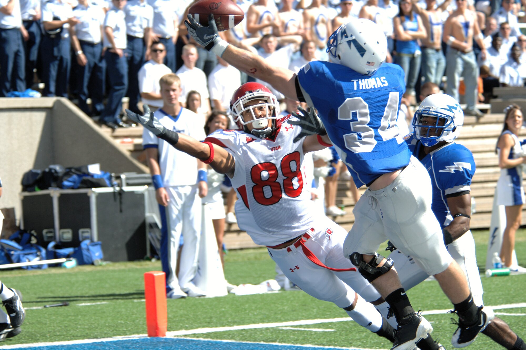 U.S. Air Force Academy safety Chris Thomas stretches to deflect a pass intended for Utah wide receiver Freddie Brown while Falcons cornerback Reggie Rembert trails Sept. 20 at the Academy in Colorado. Rembert hauled in the deflection for an interception in the end zone, ending the Utah drive. (U.S. Air Force photo/John Van Winkle) 
