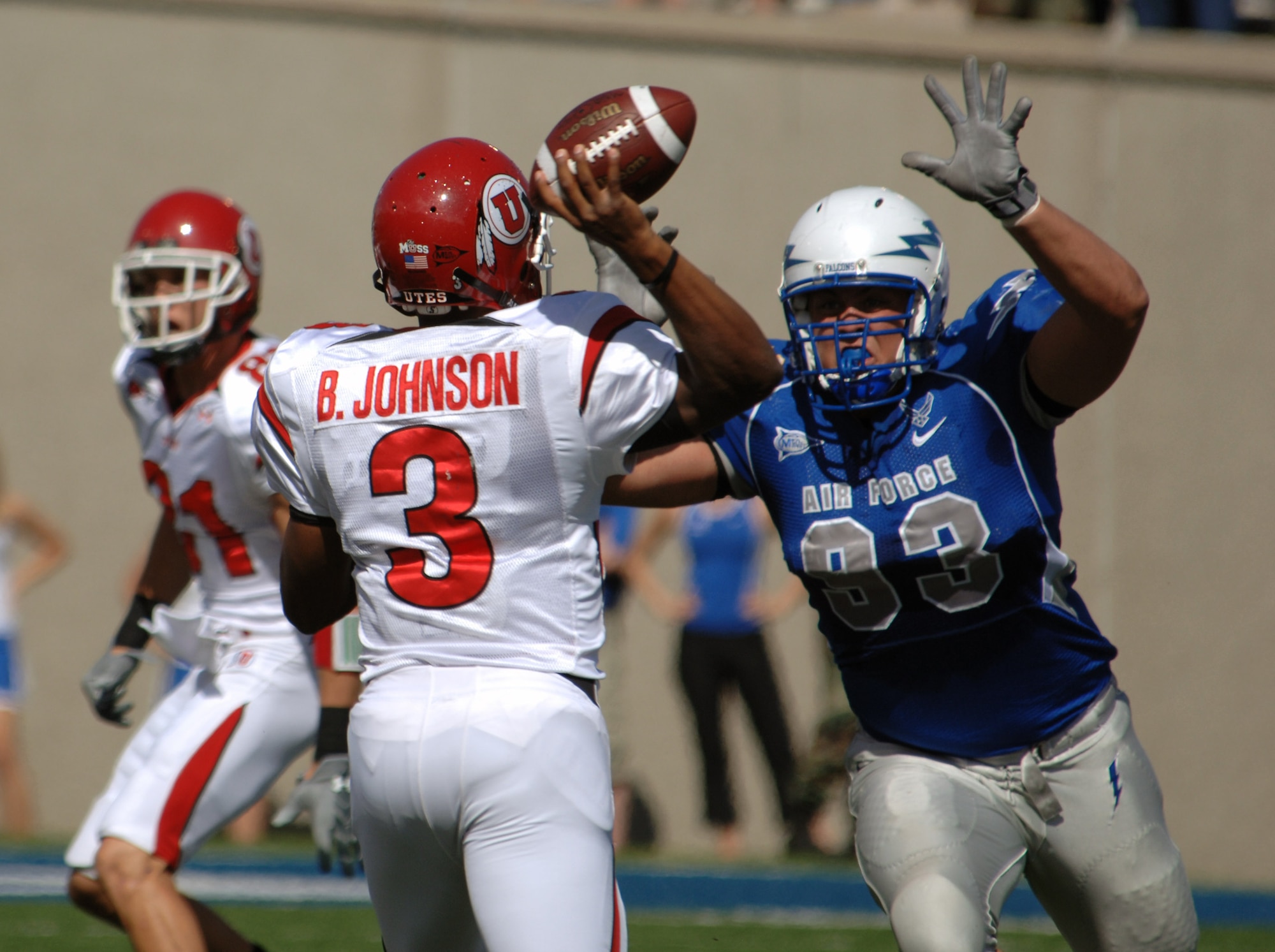 Utah quarterback Brian Johnson gets a face full of U.S. Air Force Academy noseguard Ben Garland as he tries to unload a pass downfield Sept. 20 at the Academy in Colorado. From the middle of the 3-4 defense, Garland made four tackles, one tackle for loss and forced one fumble. (U.S. Air Force photo/John Van Winkle) 
