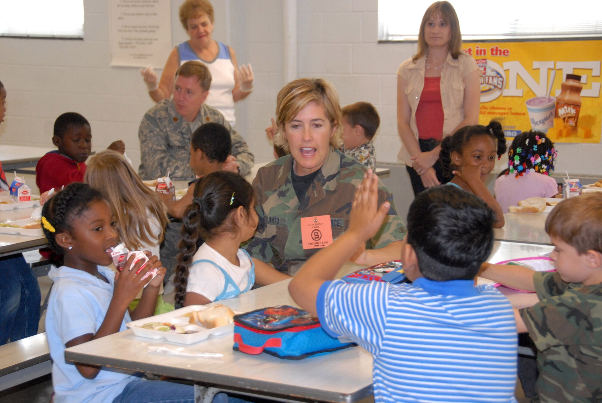 Master Sgt. Amy Giaquinto talks with students at Yates Elementary School during their lunch. (U.S. Air Foce photo by Master Sgt. Christine Wood)