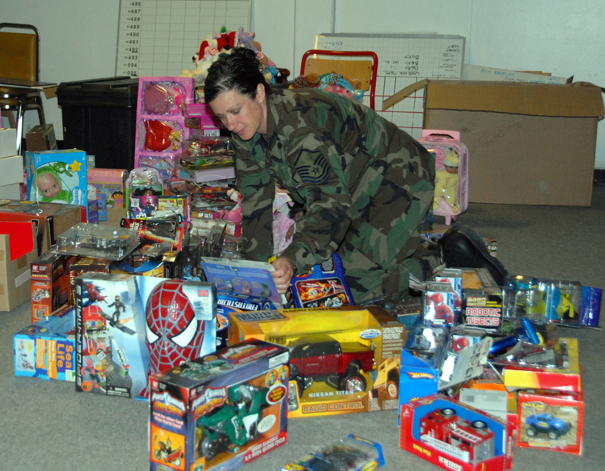 Master Sgt. Kelly Archambeault organizes toys donated by Toys R Us. The toys were handed out to students in Greenland. (U.S. Air Force photo by Master Sgt. Christine Wood)